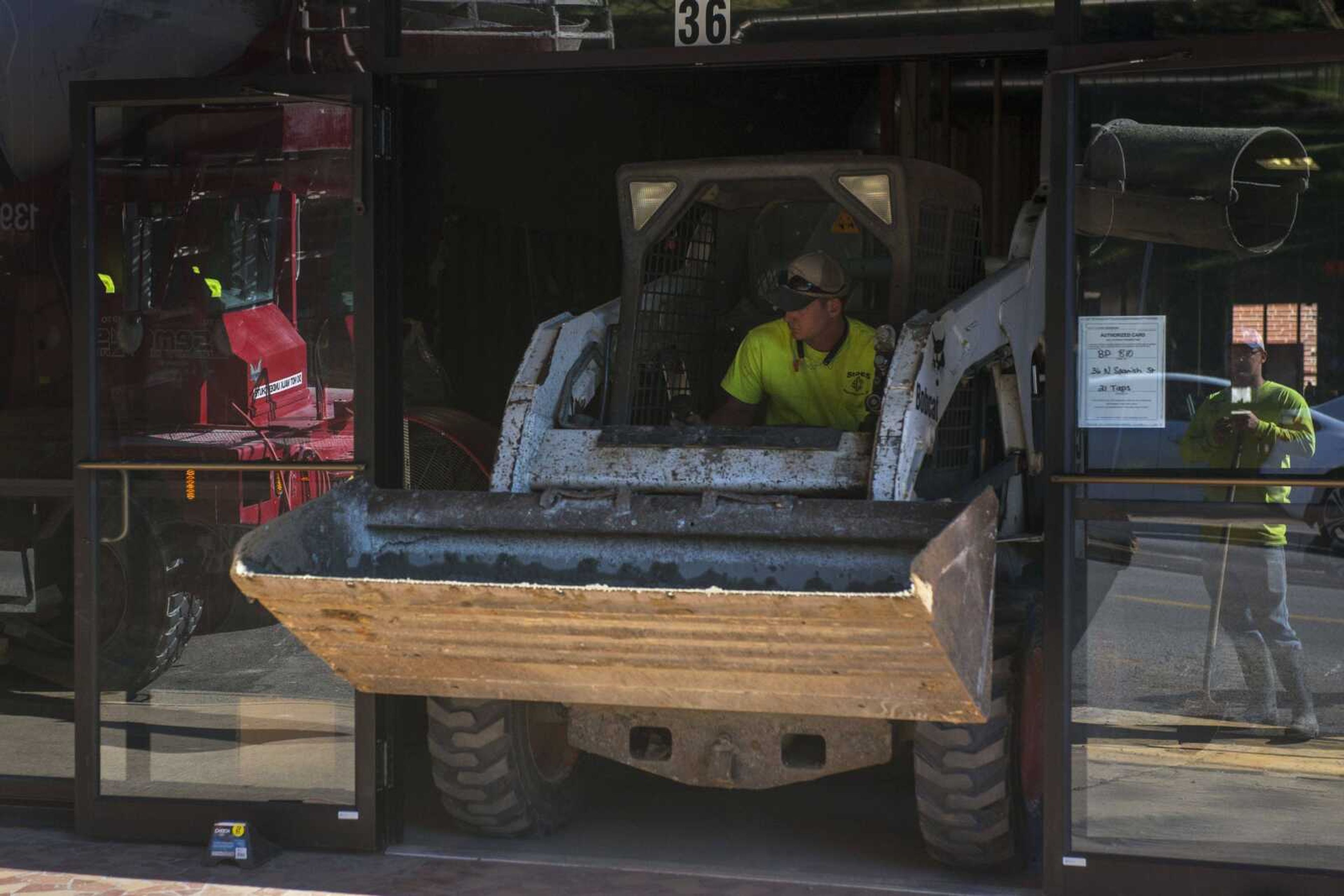 TYLER GRAEF ~ tgraef@semissourian.com    Crews work to install concrete inside 36 North Spanish Street Thursday. The space which will soon house a new bar, 21 Taps.