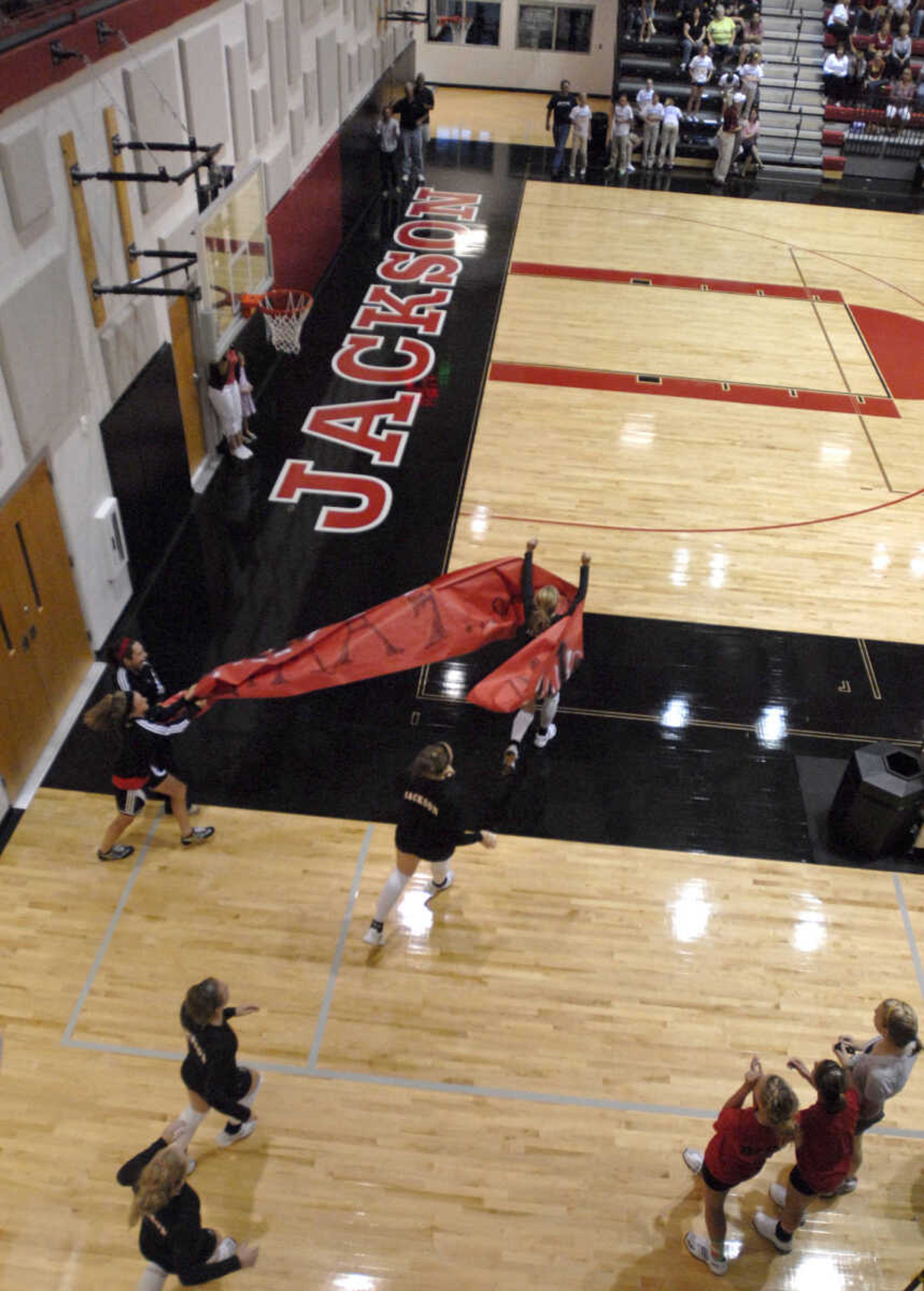 FRED LYNCH ~ flynch@semissourian.com
Jackson volleyball players run out to the court for their first game in the new gymnasium.