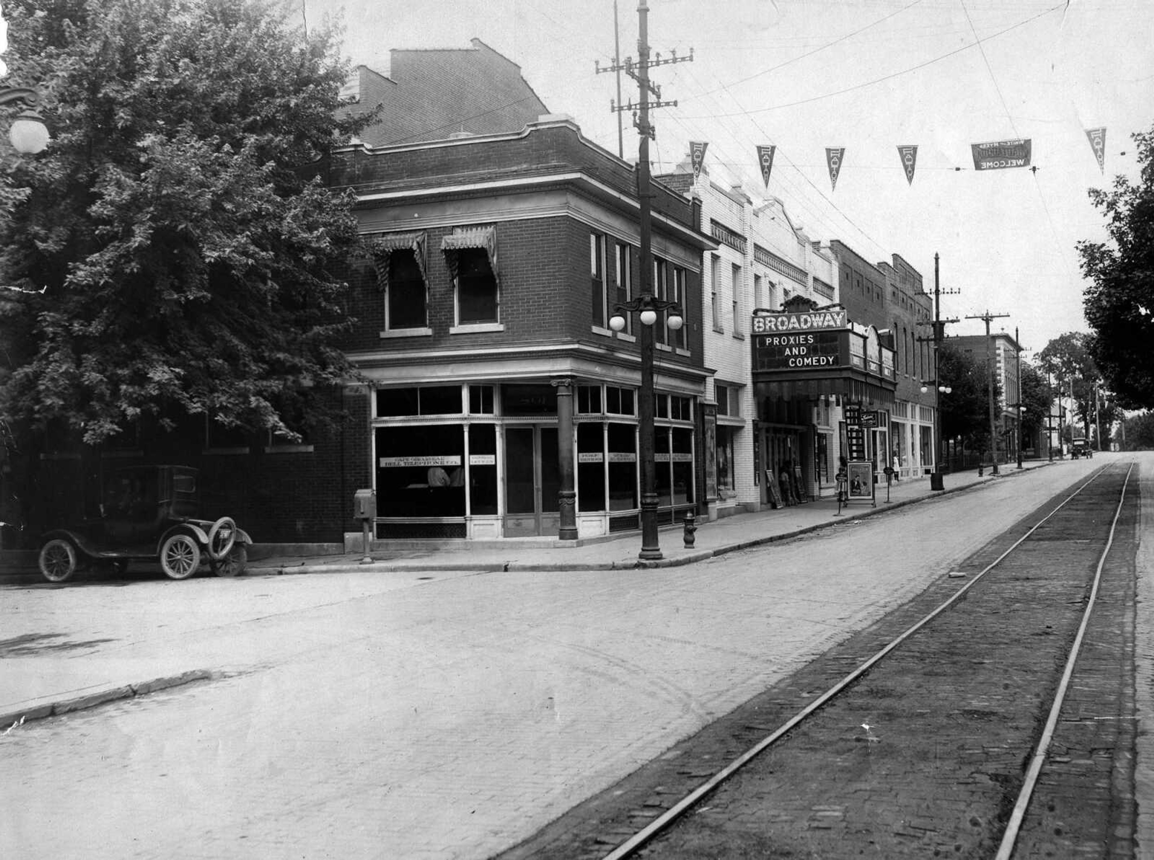 Children can be seen peaking through the front door  of the Broadway Theater in this early 1920s picture, which provides a good view of the south side of Broadway in the 800 block.
The movie "Proxies" was released in 1921, but the White-Myers Chautauqua advertised in the street banner played Cape Girardeau in 1920.