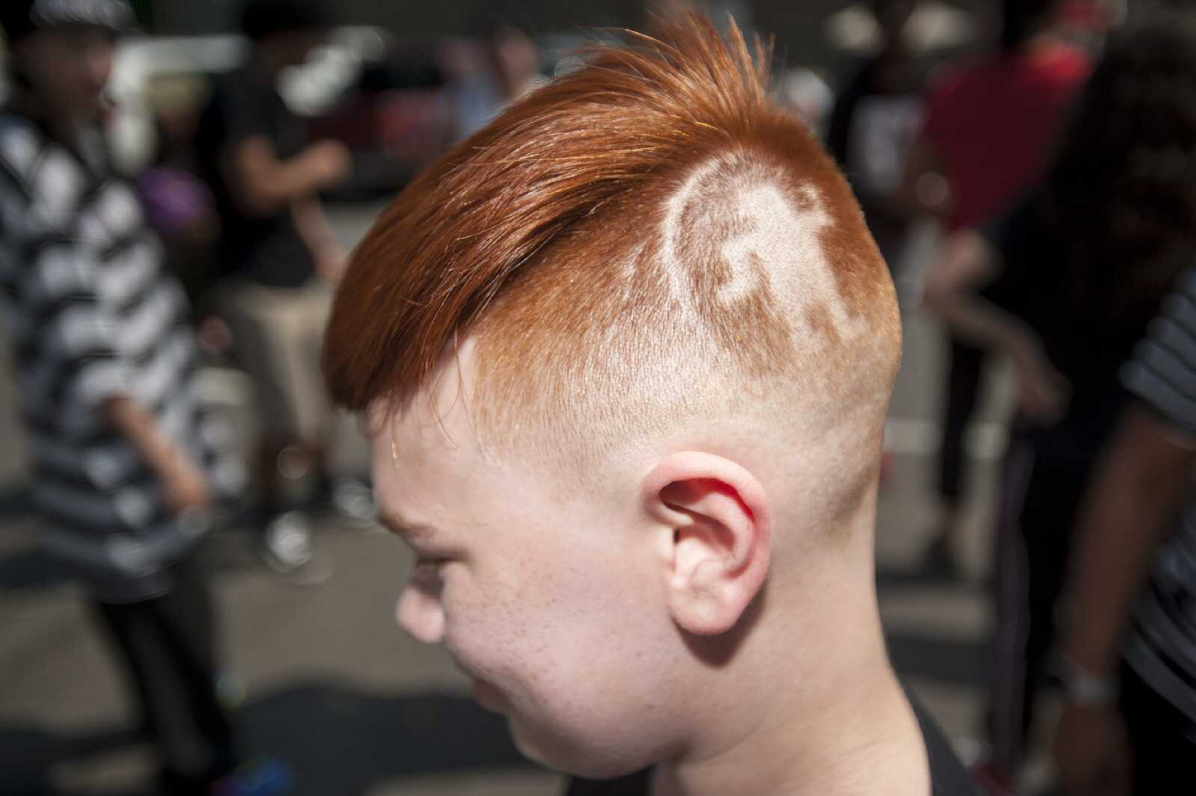 A dancing man shaved into the hair of dancer Jace Darrah, 11, is seen during the Cape Be You Urban Dance on Saturday at Fingerprint Dance Studio in downtown Cape Girardeau.