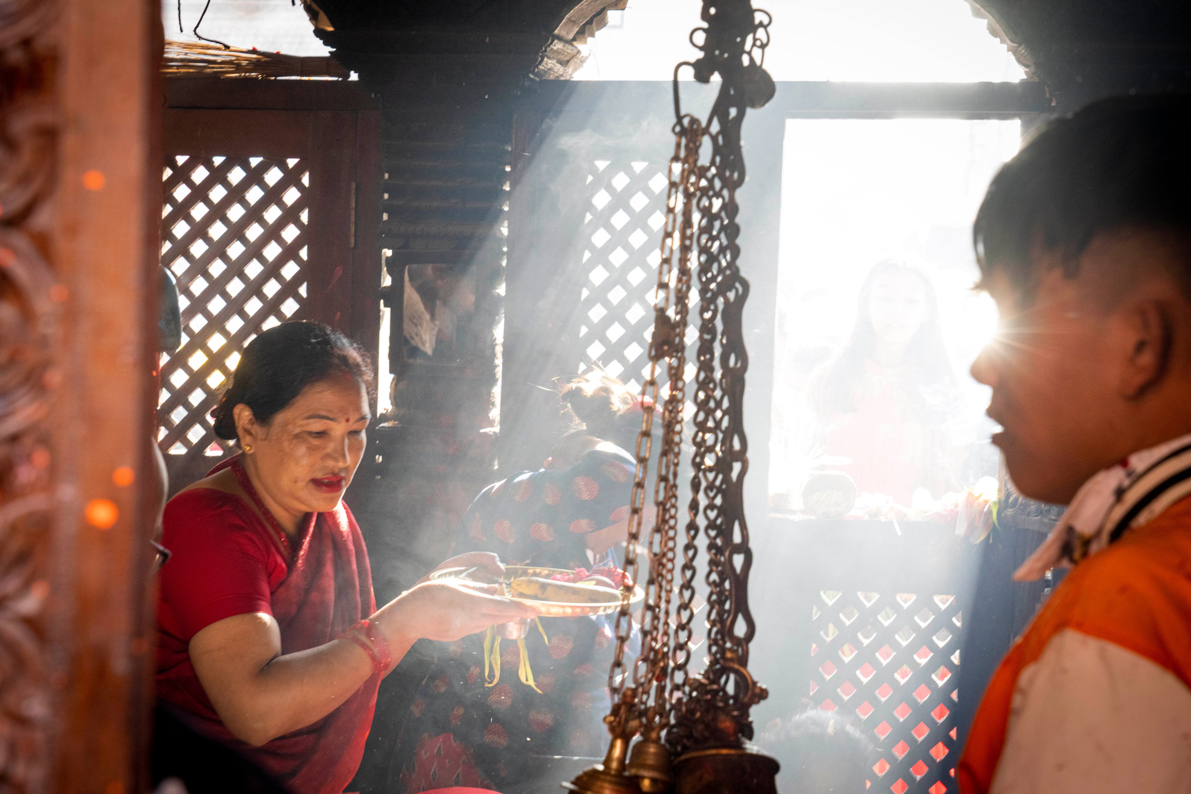 Devotees wait to perform rituals inside the Balkumari Temple during Dashain festival in Thimi, Bhaktapur, Nepal, Friday, Oct. 11, 2024. The festival commemorates the slaying of a demon king by Hindu goddess Durga, marking the victory of good over evil. (AP Photo/Niranjan Shrestha)