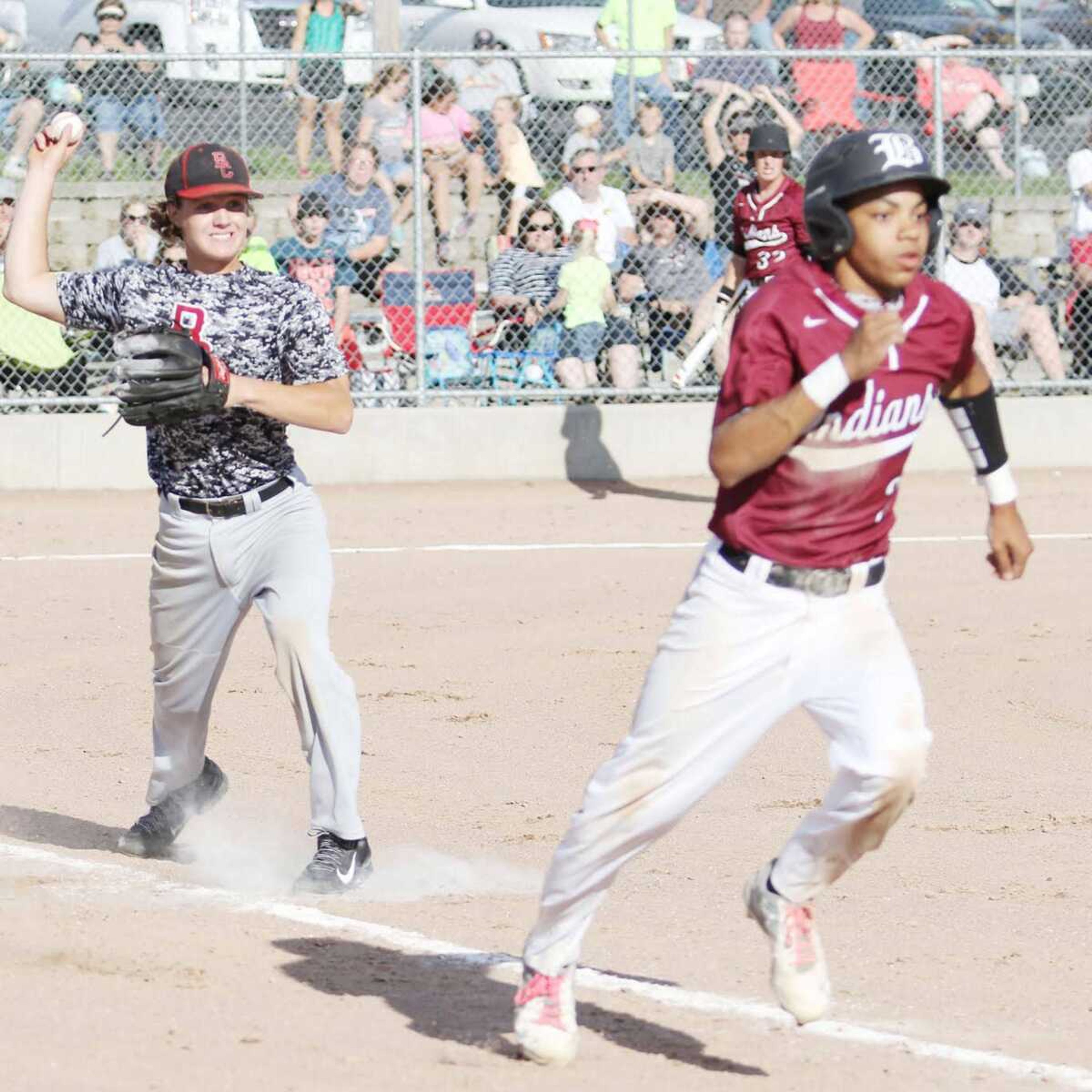 Bell City starting pitcher Austin Hicks throws out Bismarck No. 2 hitter Malcolm Hawkins at first base.