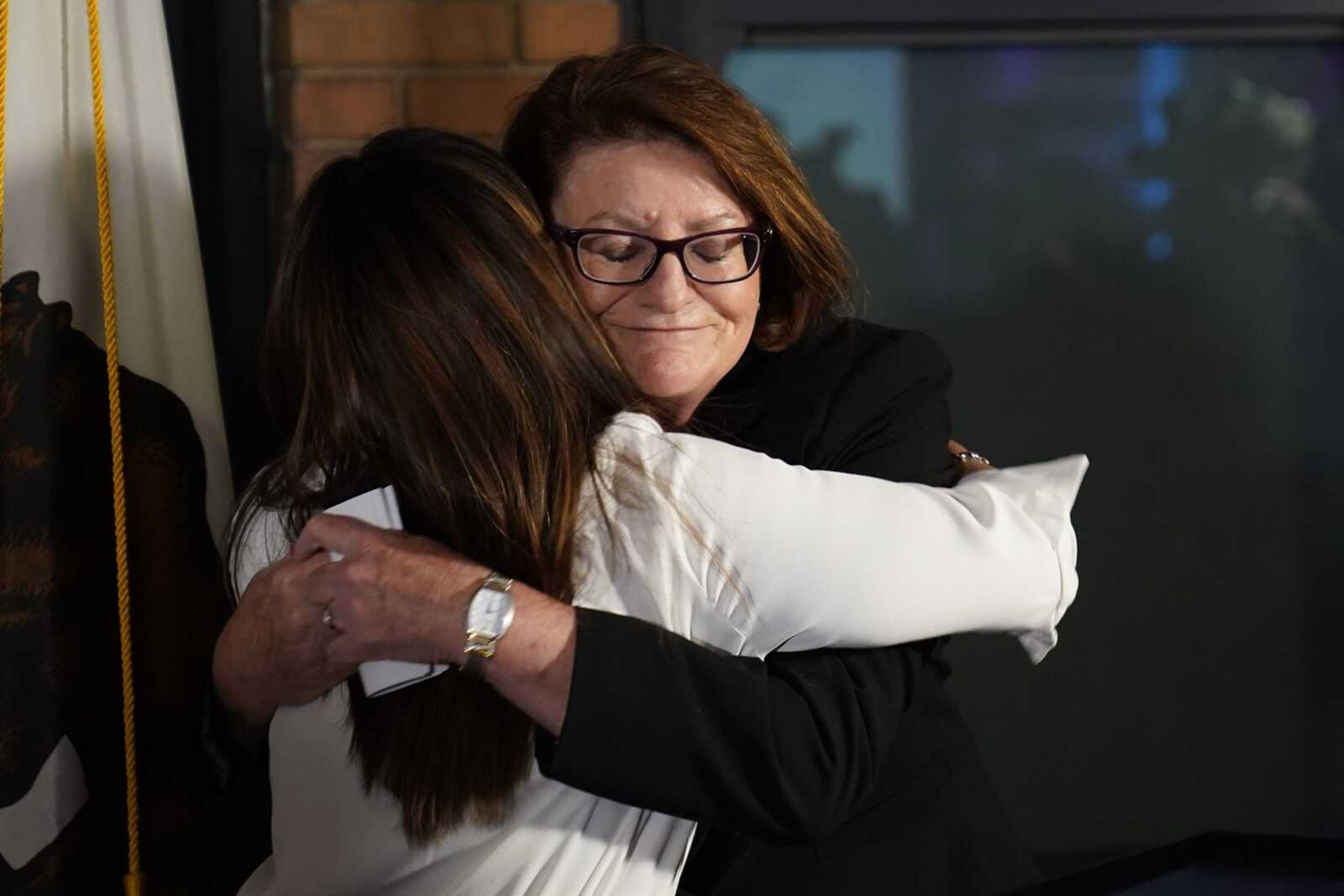 California state Senate President Pro Tempore Toni Atkins, right, hugs Jodie Hicks, chief executive officer and president of Planned Parenthood Affiliates of California, at a gathering in support of Proposition 1, on Tuesday, Nov. 8, in Sacramento, California.