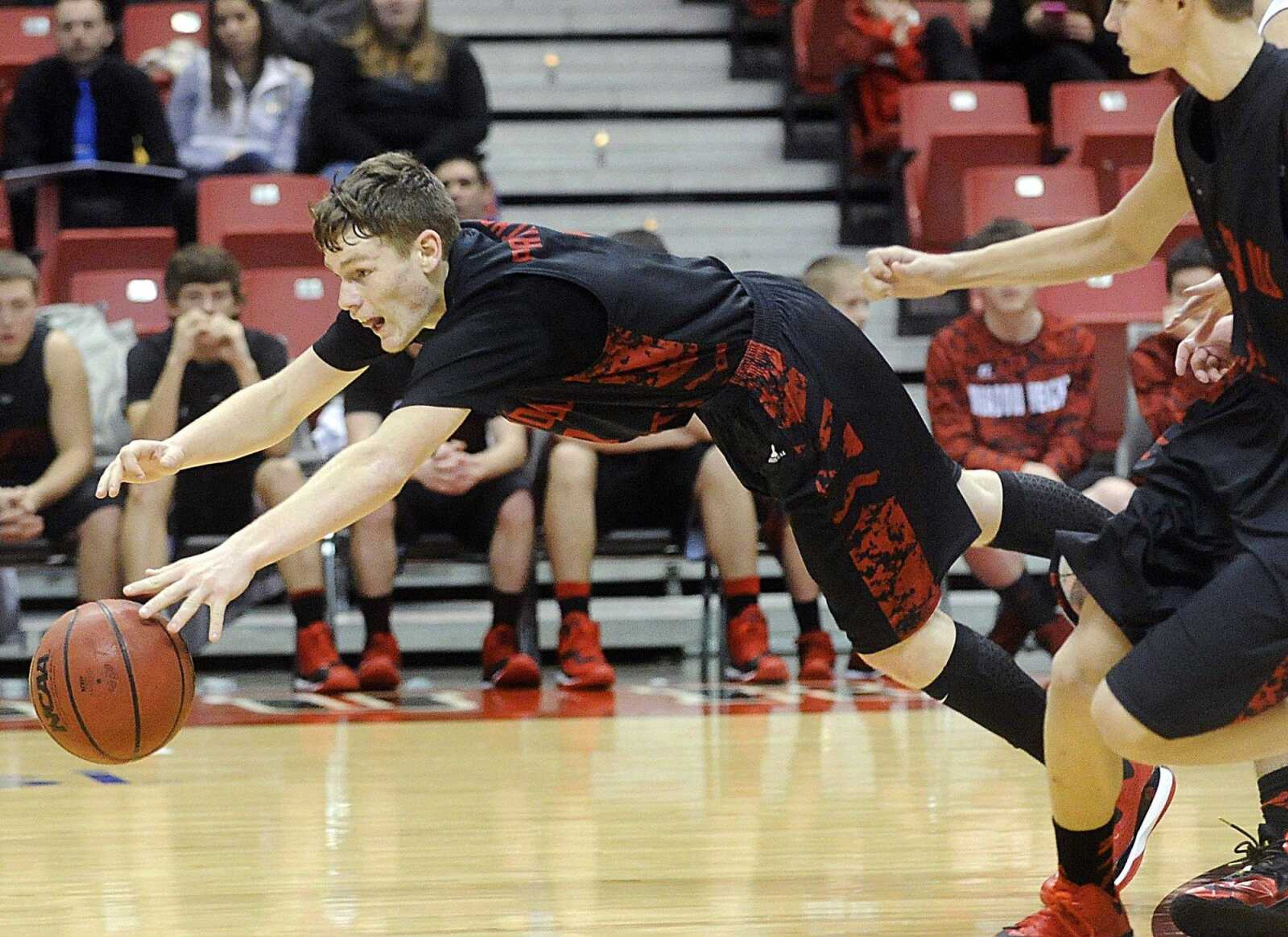 Meadow Heights  Jacob Douglas dives after a loose ball in the third quarter against Chaffee, Saturday, Dec. 27, 2014, during the consolation quarterfinal of the Southeast Missourian Christmas Tournament at the Show Me Center. Meadow Heights won 38-62. (Laura Simon)