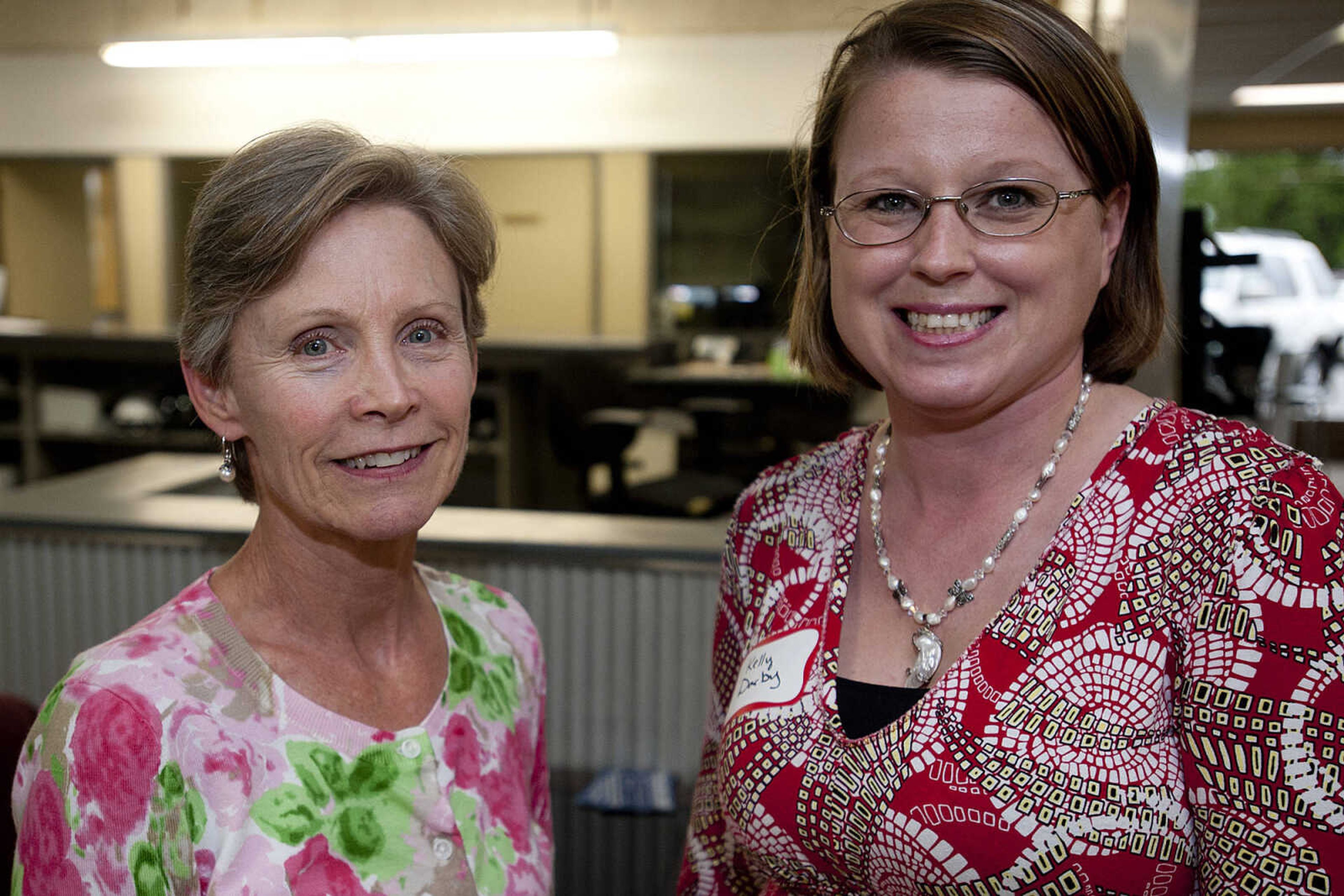 Pat Jones, left, Servicemaster and Kelly Darby, Modern Woodman, during the Jackson Area Chamber of Commerce's After Hours event Tuesday, May 13,  at First Auto Credit in Jackson, Mo.