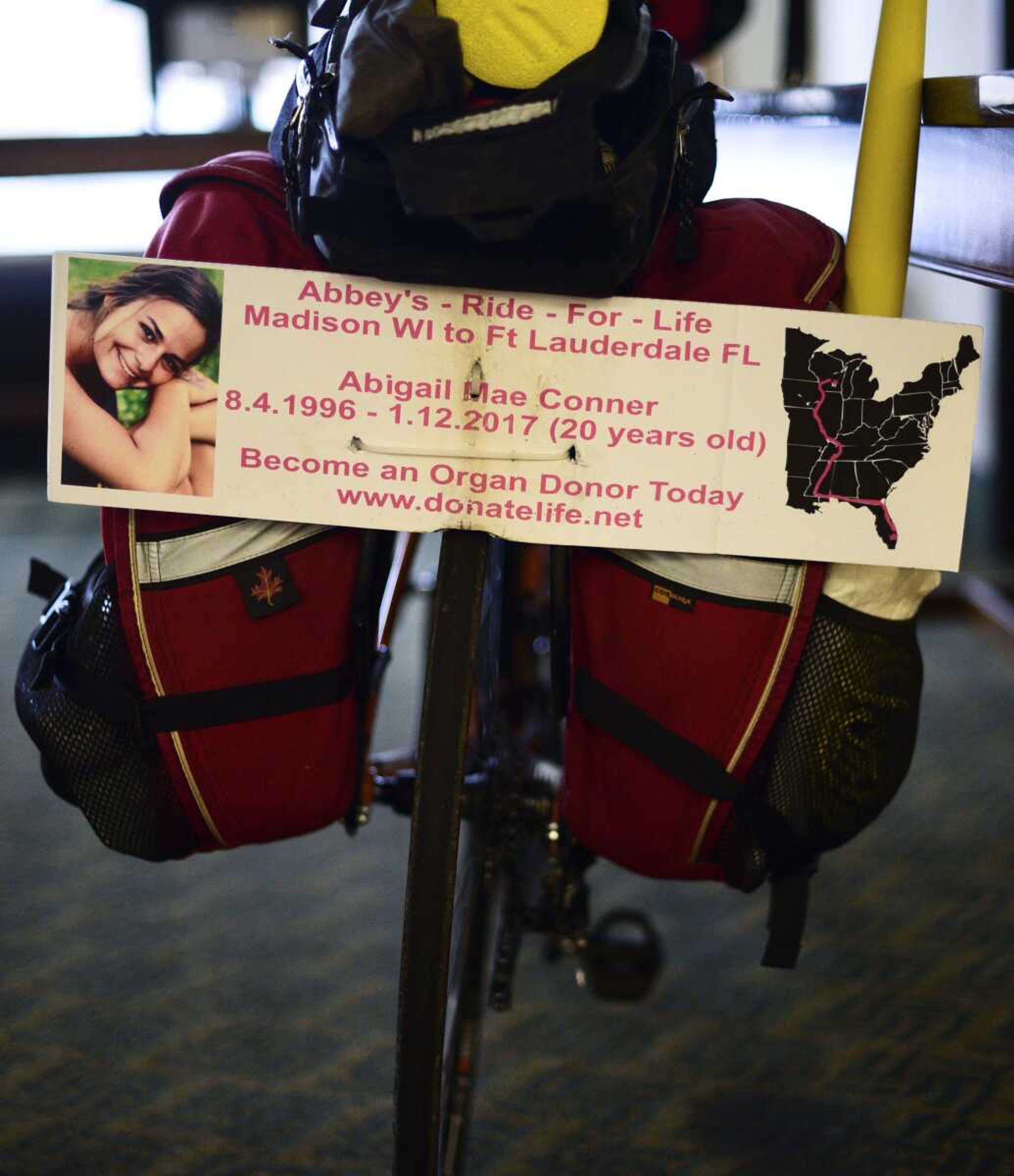 A sign remembering Abbey Conner, the daughter of Bill Conner, who is riding from Madison, Wisconsin, to Fort Lauderdale, Florida, for organ-donor awareness after his daughter was found dead in a pool in Mexico.