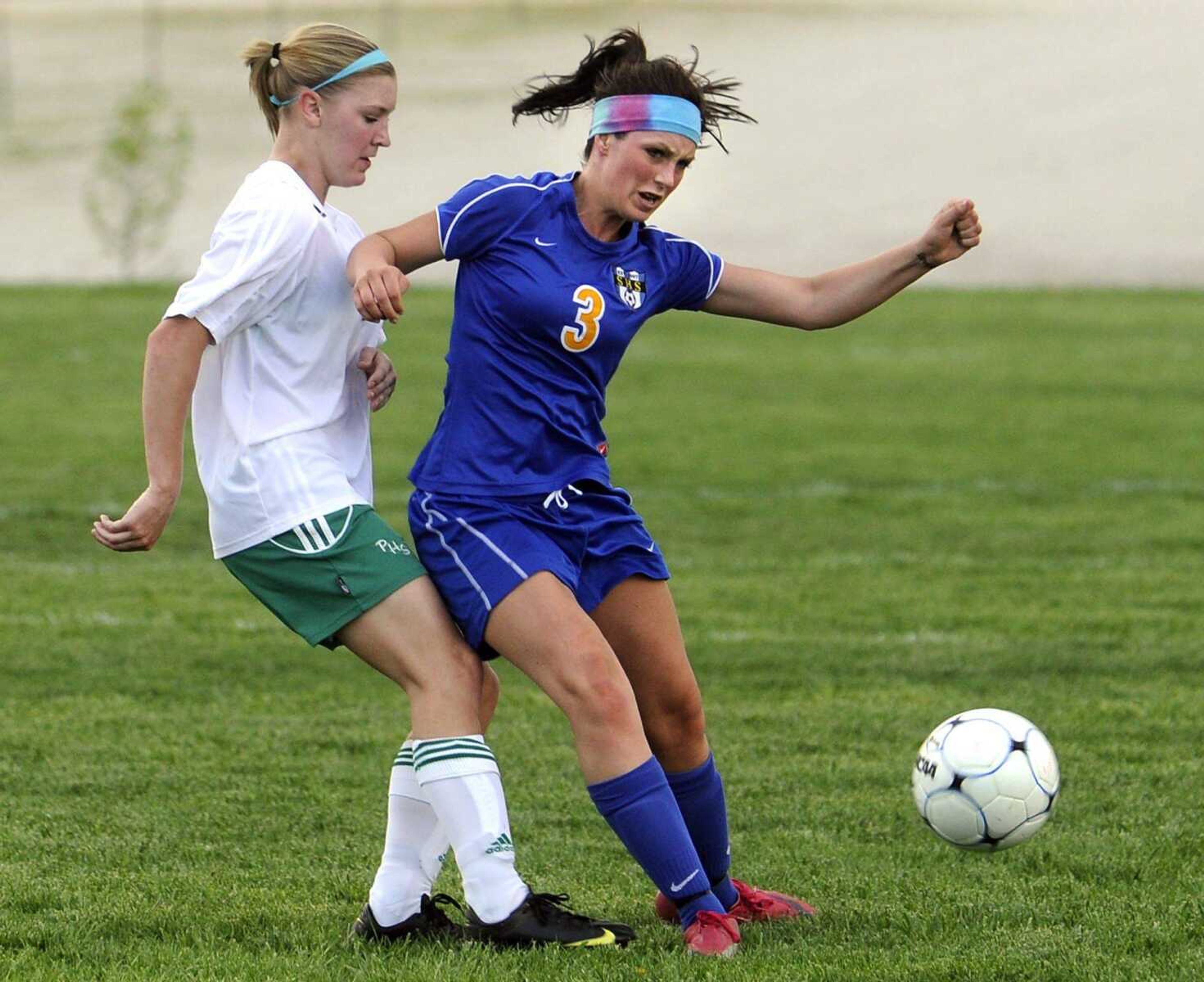 Seckman's Lauren Narzinski works the ball away from Perryville's Allison Moldenhauer during the first half Friday, March 30, 2012 in Perryville, Mo. (Fred Lynch)