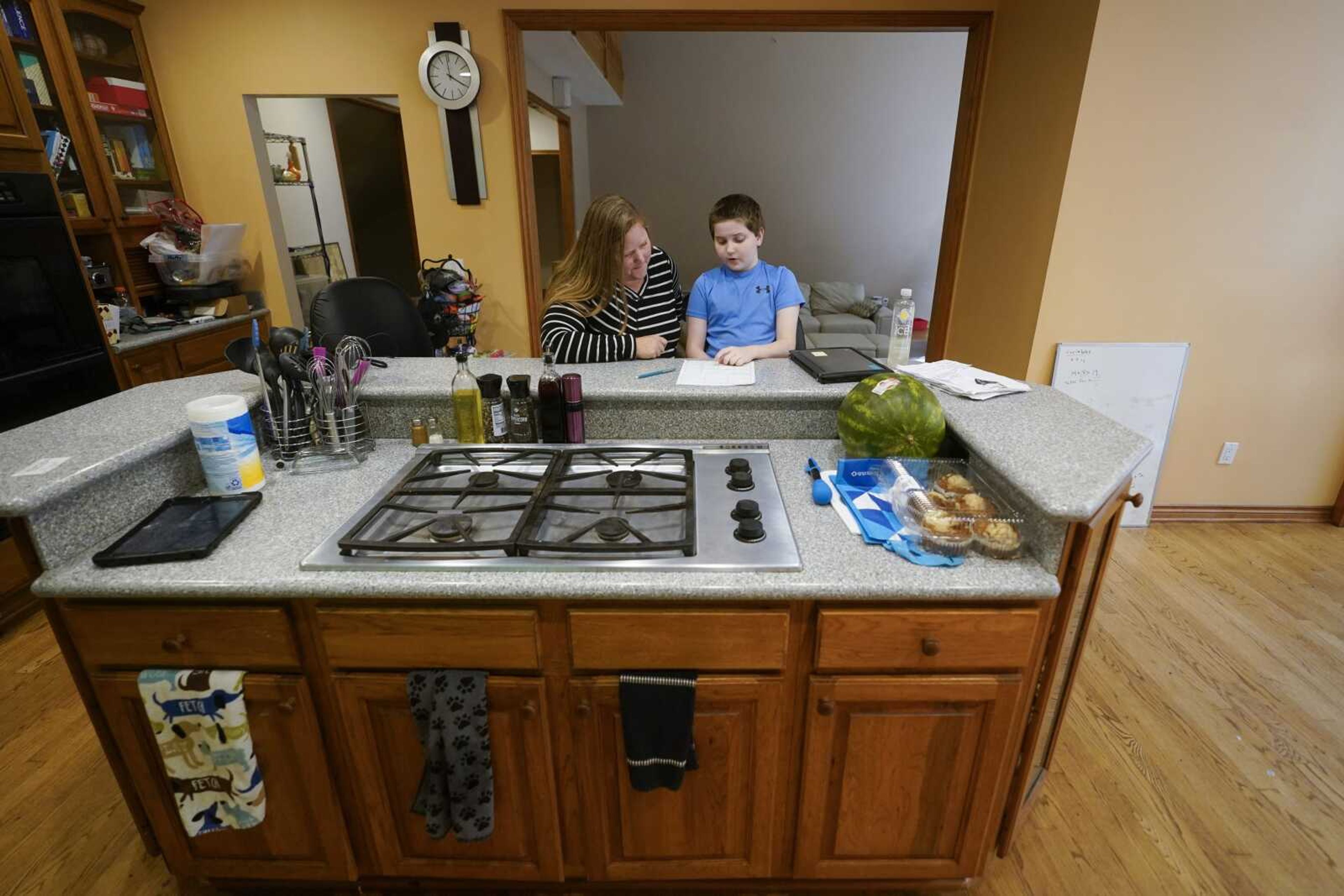 Lisa Manwell works on school work with her son John Jinks, 12, on Sept. 21 at their home in Canton, Michigan. Manwell says her son was improperly removed from his classroom last year because of behaviors that stemmed from his disability.