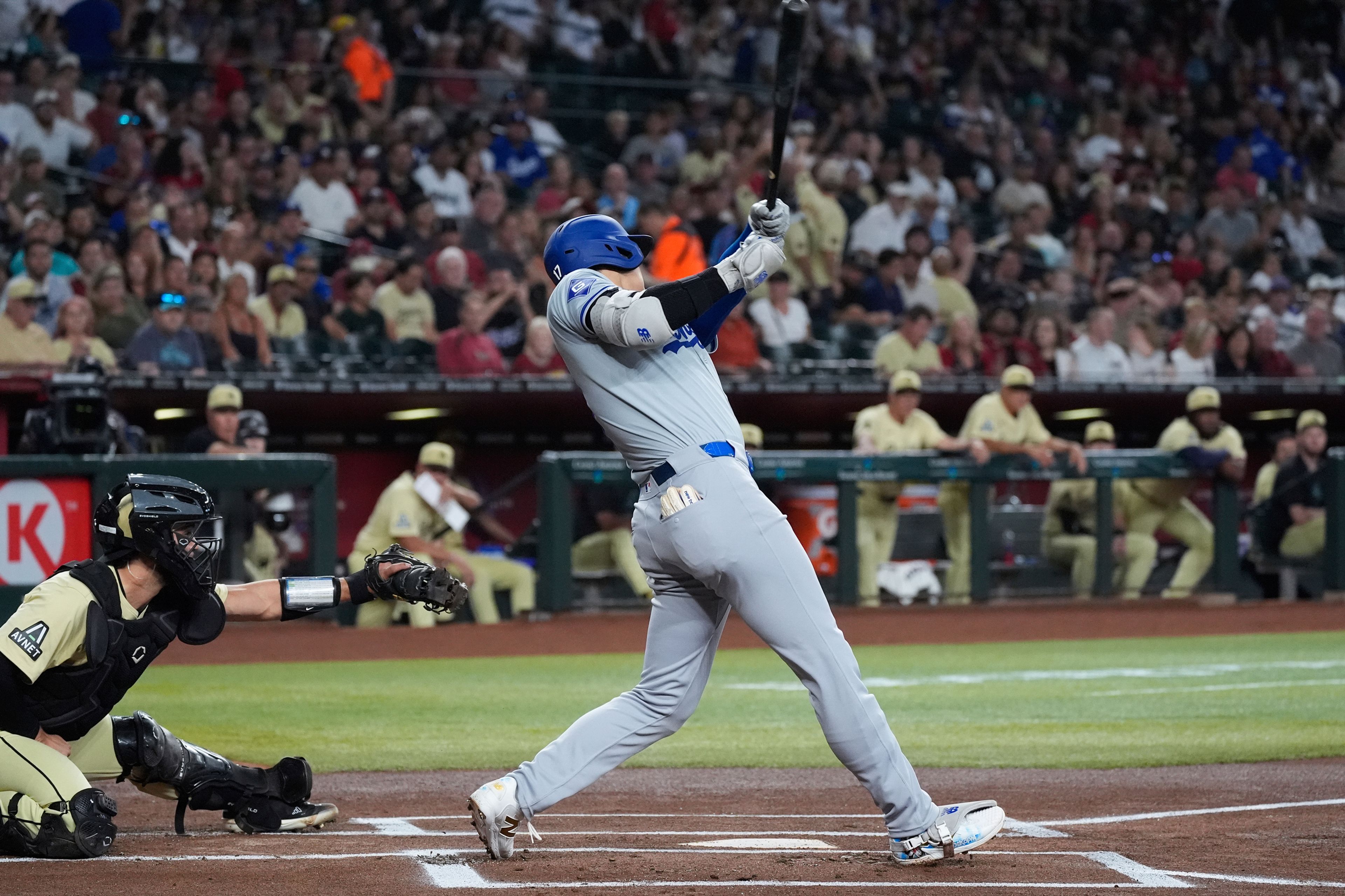 Los Angeles Dodgers designated hitter Shohei Ohtani, right, of Japan, connects for a home run as Arizona Diamondbacks catcher Adrian Del Castillo, left, looks on during the first inning of a baseball game Saturday, Aug. 31, 2024, in Phoenix. (AP Photo/Ross D. Franklin)