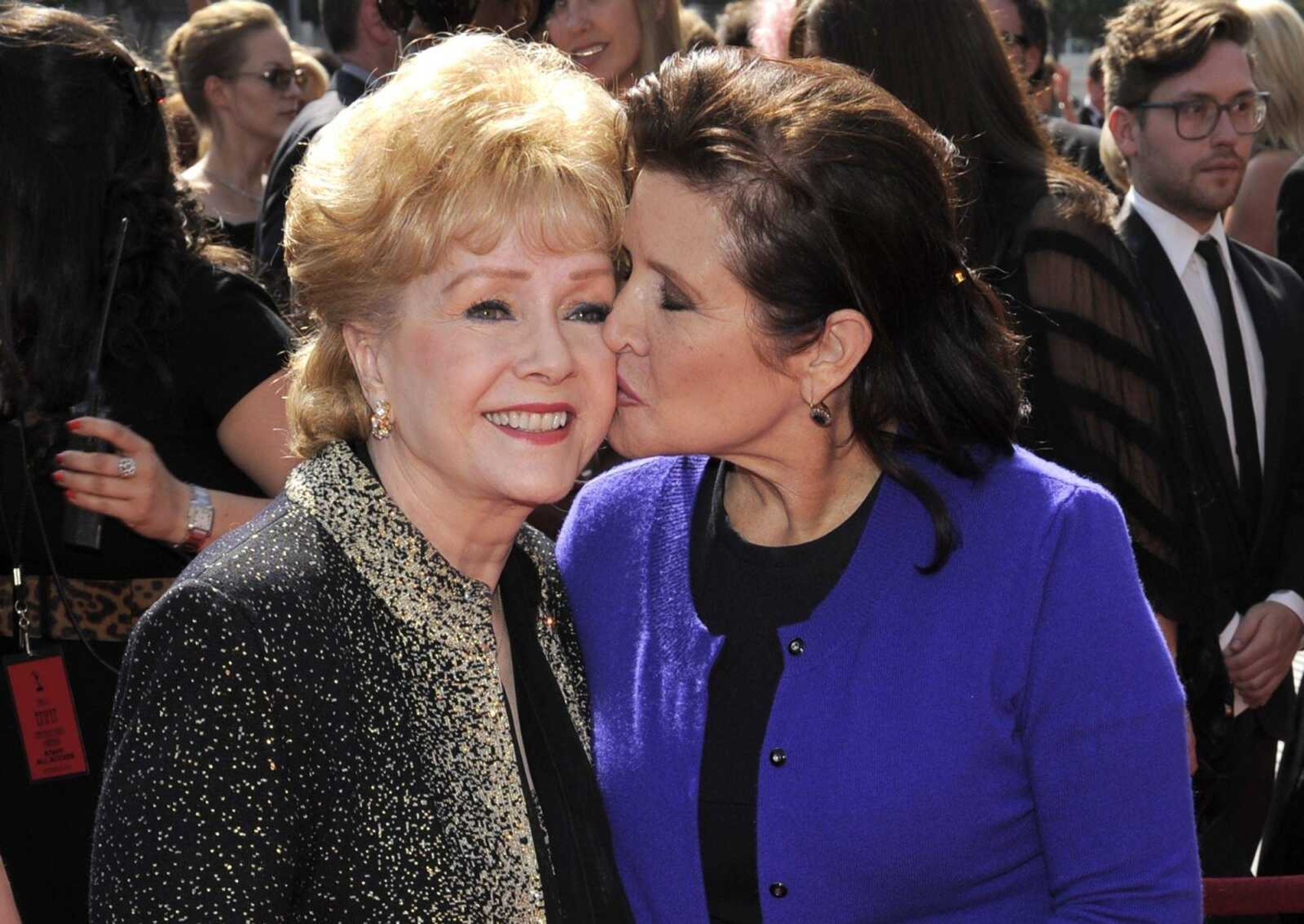 Debbie Reynolds, left, and Carrie Fisher arrive at the 2011 Primetime Creative Arts Emmy Awards in Los Angeles.