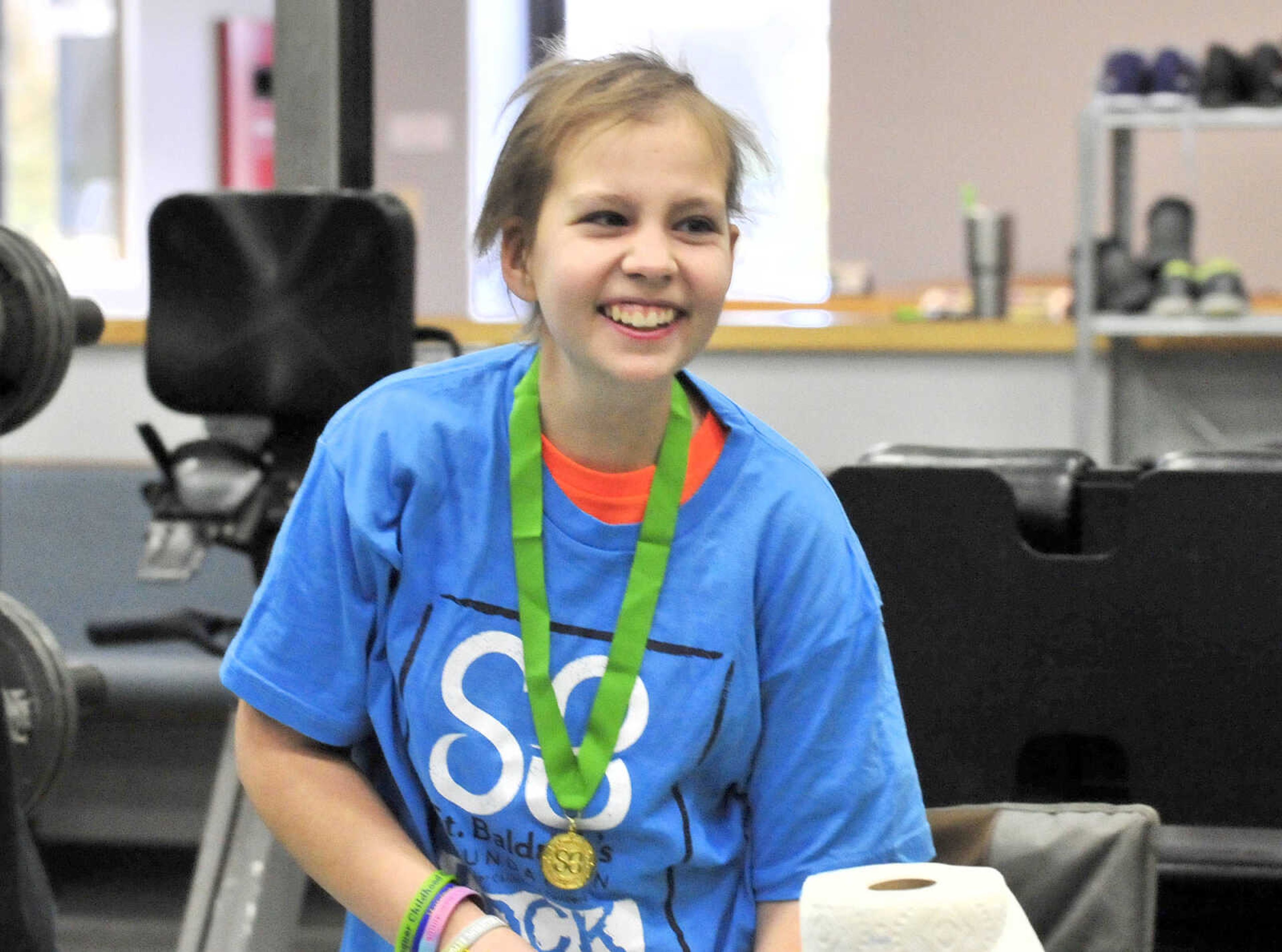 A smile radiates from Sarah Singleton on Saturday, March 4, 2017, during the St. Baldrick's Foundation fundraiser at Old Orchard CrossFit in Jackson.