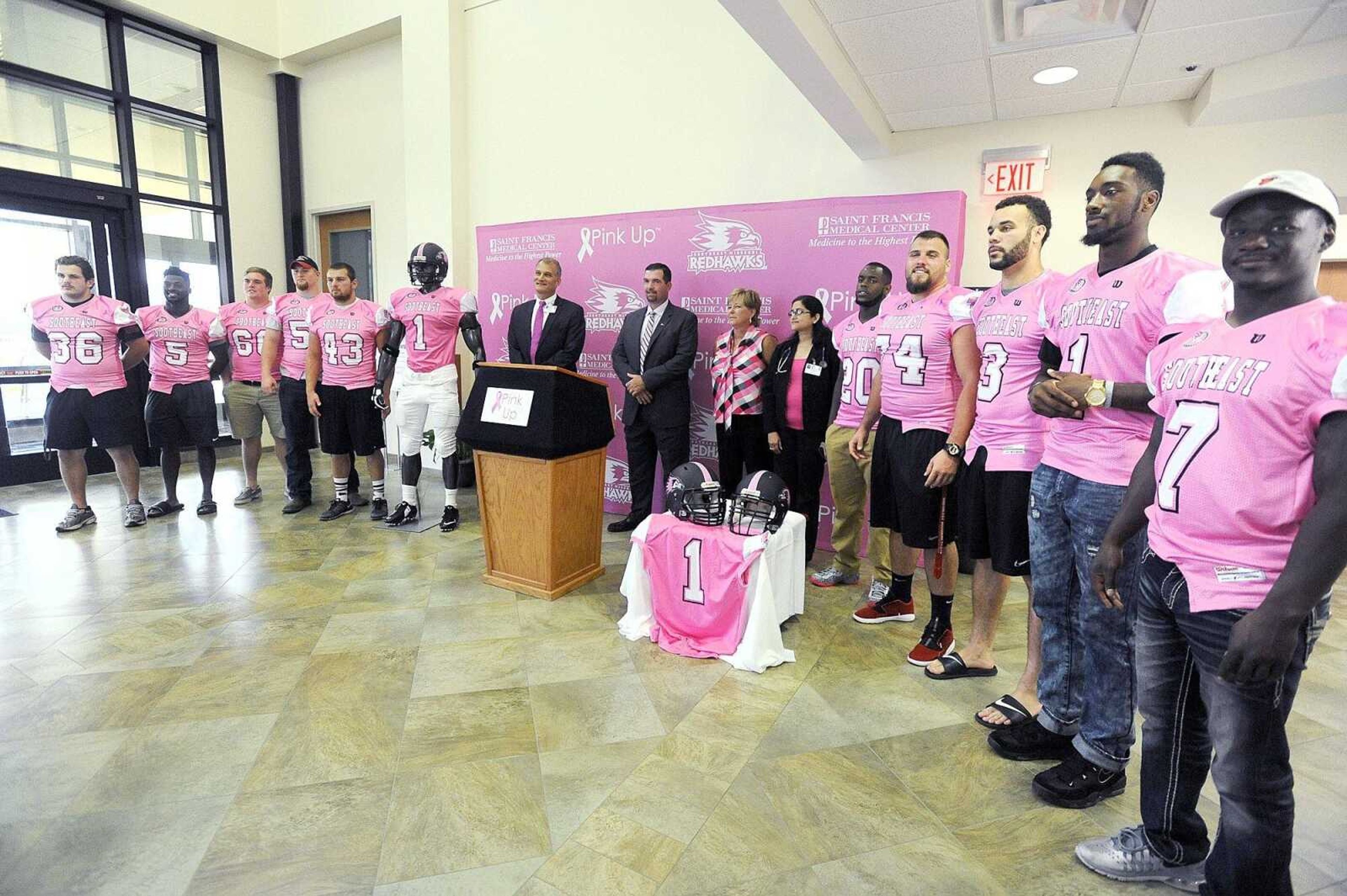 Southeast Missouri State football players line up for a photo in their pink jerseys during a joint press conference at Saint Francis Medical Center, Wednesday, Aug. 12, 2015. The jerseys will be worn during a home football game, and then auctioned off. The proceeds will go to Pink Up, a program that offers free breast cancer screenings to those who could otherwise not afford one. (Laura Simon)