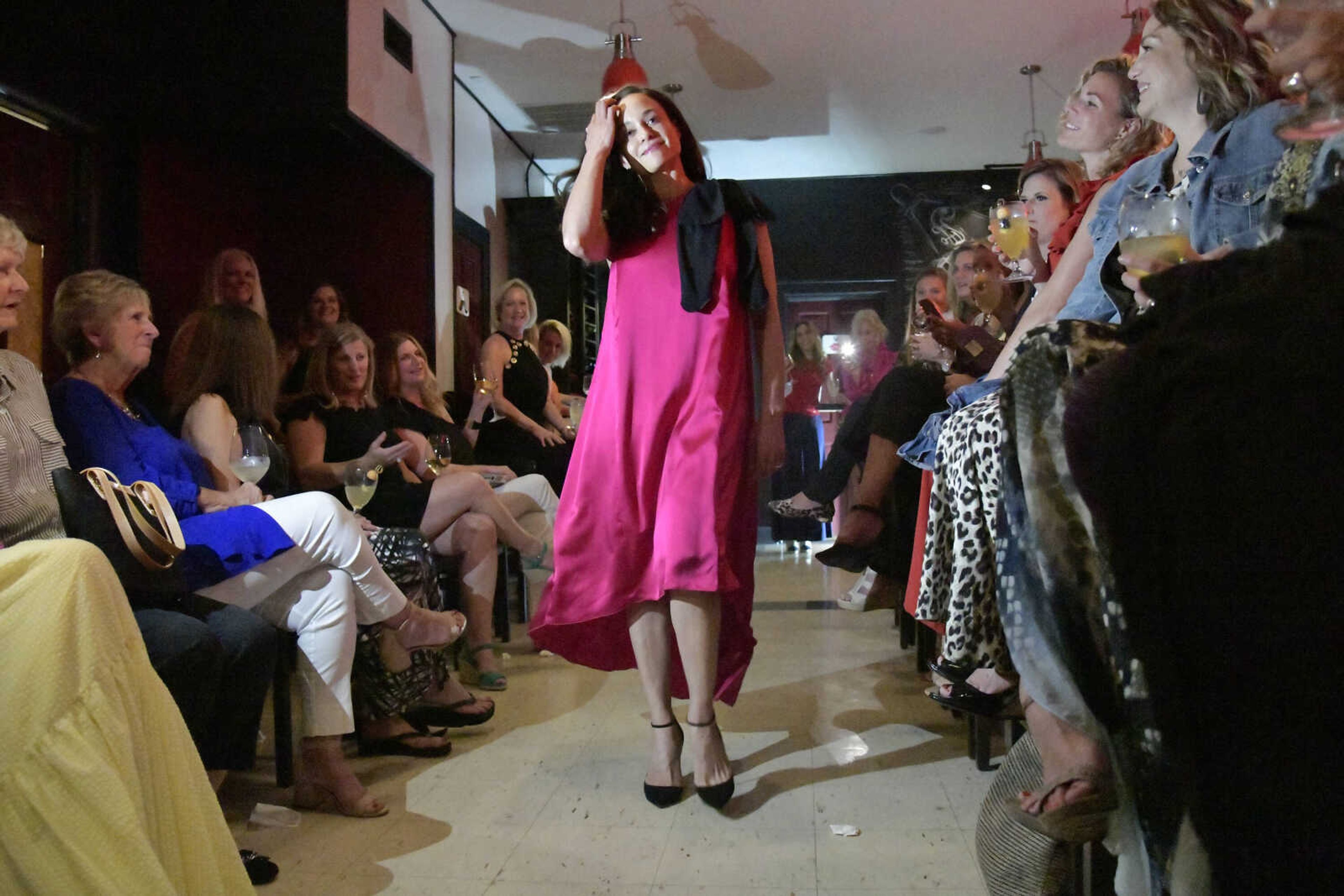 Lead stylist Alejandra Humphrey models an evening wear outfit during the Aesthete Luxury Resale fashion show at Le Bistro at The Bar in Cape Girardeau on Tuesday, June 8, 2021.