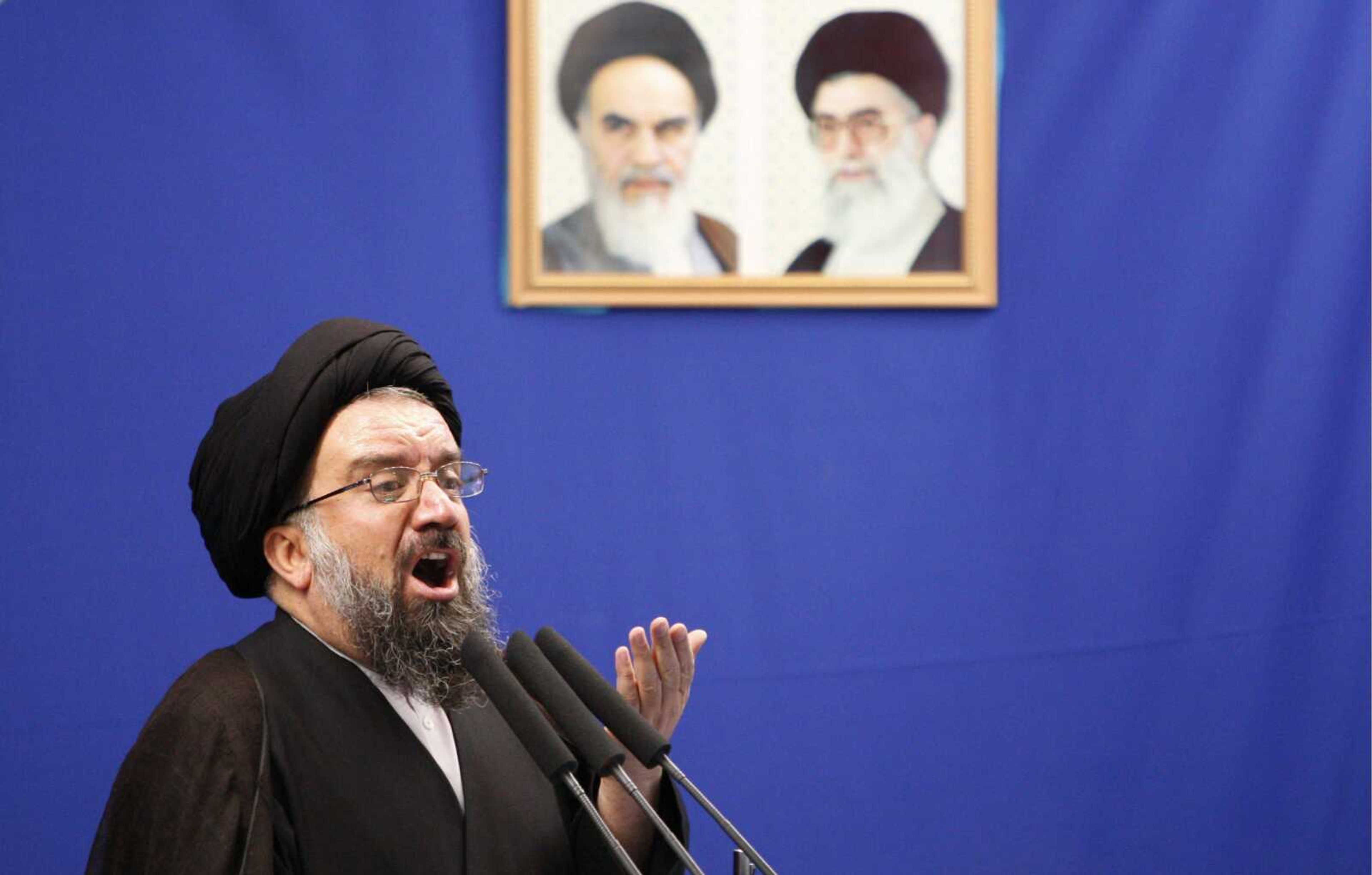 Iranian senior hard-line cleric Ayatollah Ahmed Khatami delivers a Friday prayer sermon under the pictures of late revolutionary founder Ayatollah Khomeini, left, and supreme leader Ayatollah Ali Khamenei, at the Tehran University campus in Tehran, Iran. Khatami urged government to punish post-election rioters. (VAHID SALEMI ~ Associated Press)