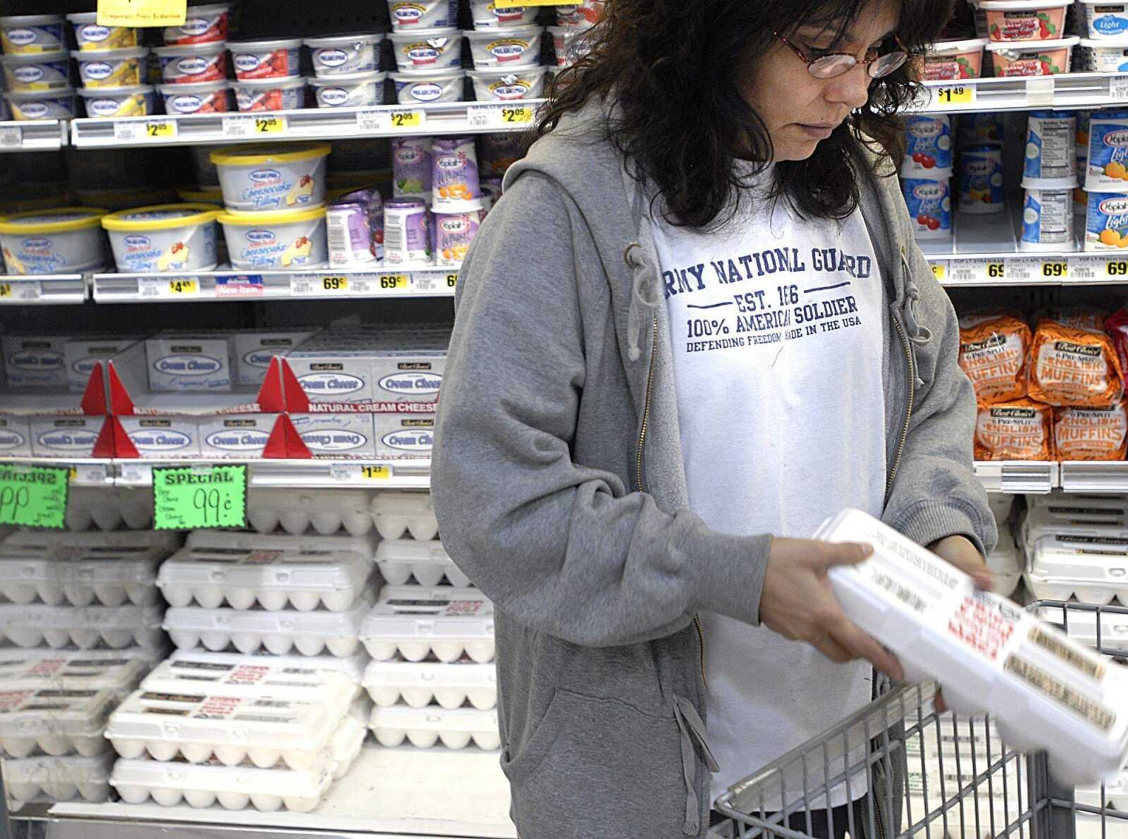 Lupe Drum selected a carton of eggs Monday at Country Mart in Jackson. The price of eggs has gone up to about $2 per dozen in recent weeks. (Aaron Eisenhauer)