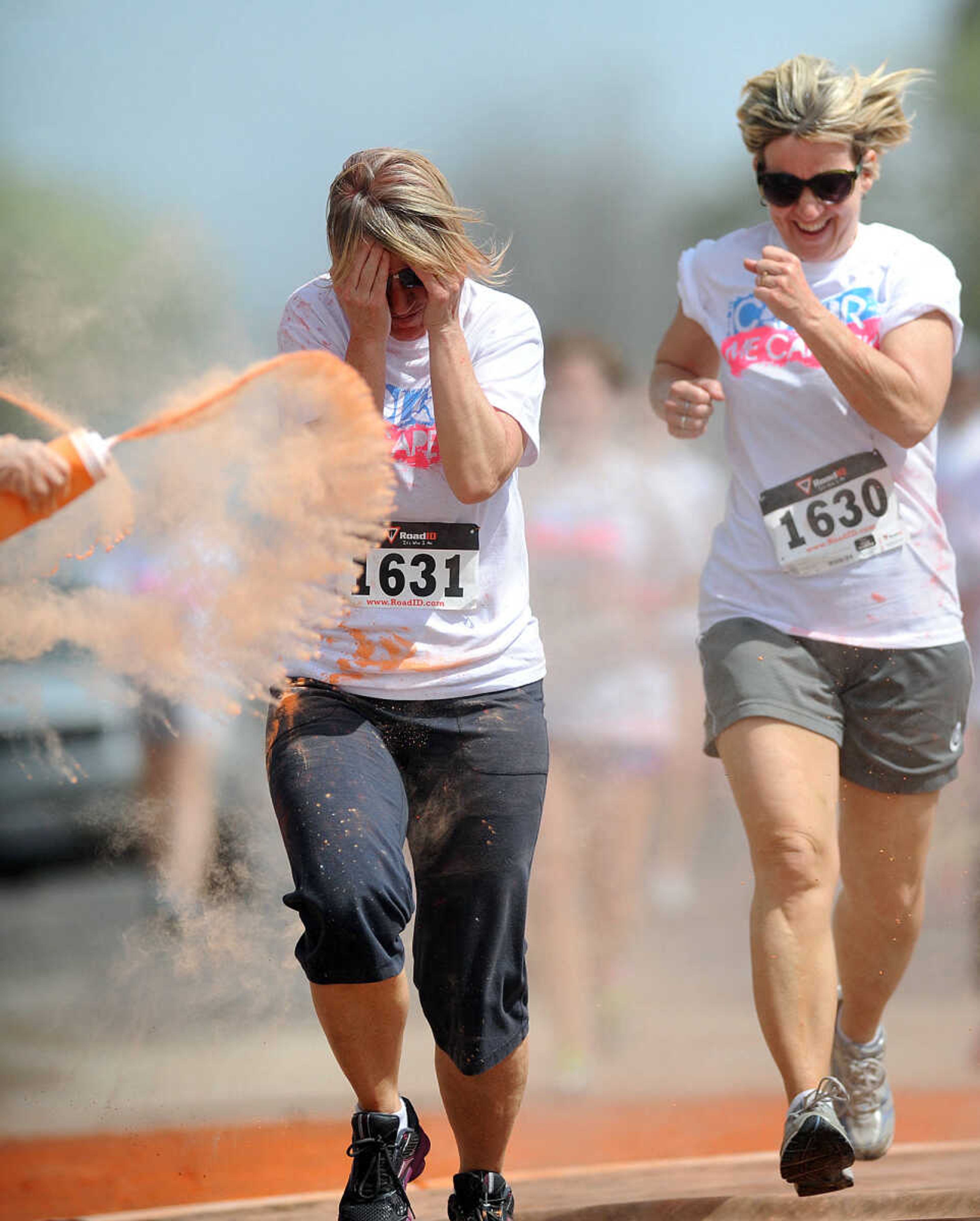 LAURA SIMON ~ lsimon@semissourian.com

Participants in the Color Me Cape 5K are sprayed with orange powder at the first color station on Good Hope Street, Saturday, April 12, 2014, in Cape Girardeau.