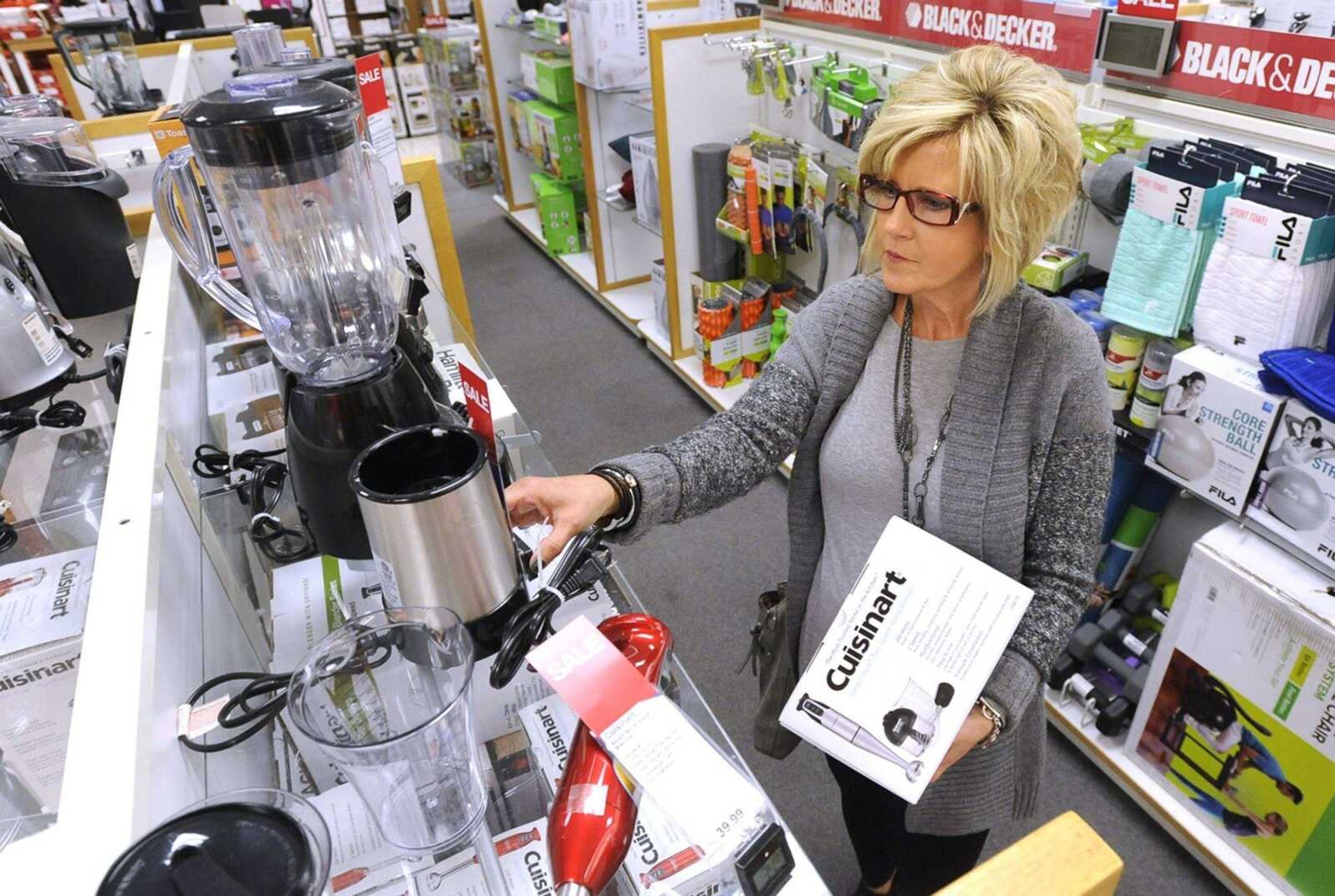 Karen Waller considers small kitchen appliances Tuesday at Kohl's in Cape Girardeau. "I have $50 that I have to spend," she said. Waller decided to buy a slow cooker that was sale-priced $8 over her budget.
