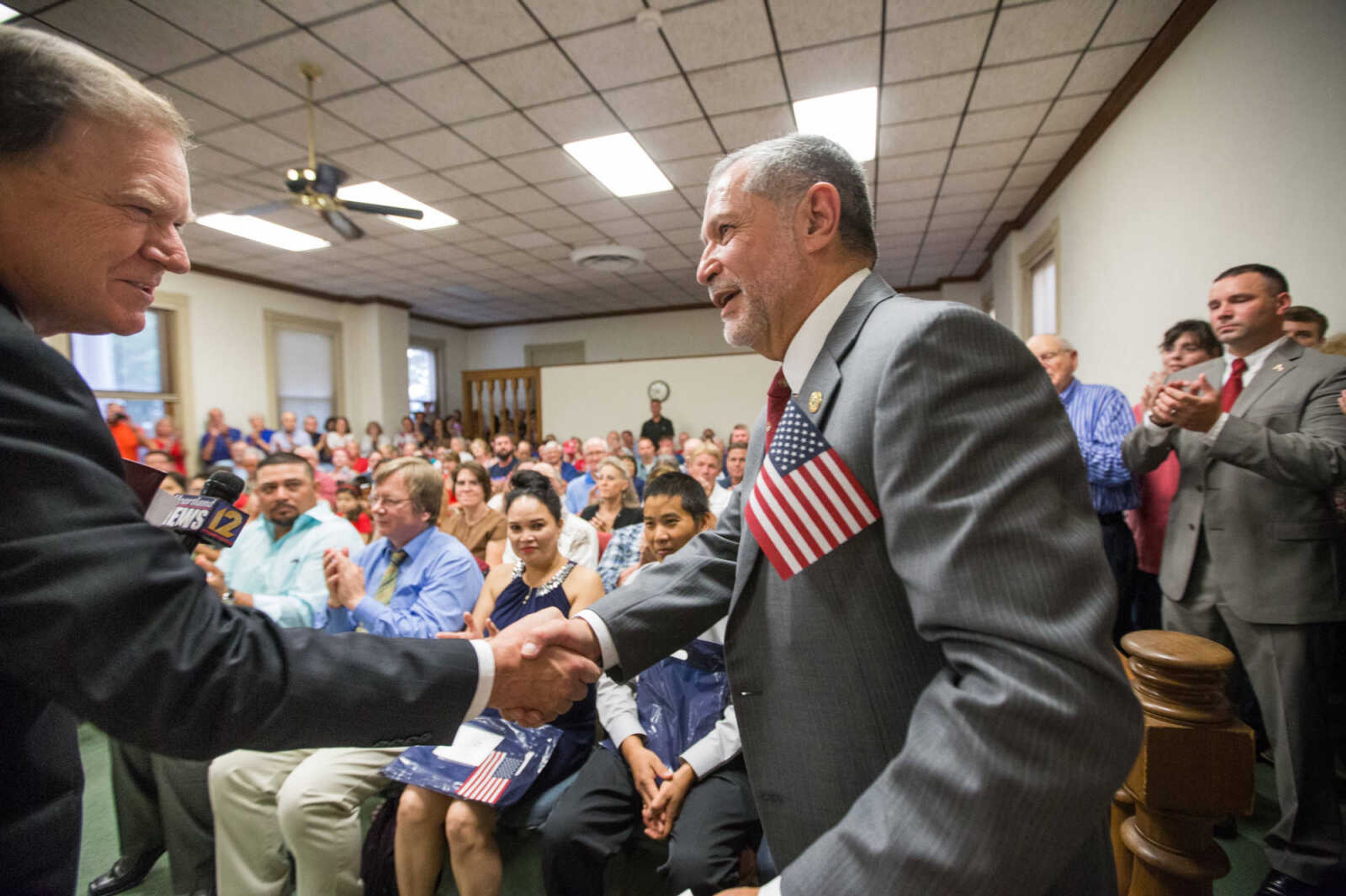 GLENN LANDBERG ~ glandberg@semissourian.com

Southeast Missouri State University president Carlos Vargas-Aburto shakes hands with assistant U.S. attorney Larry H. Ferrell after being sworn in as a U.S. citizen during a naturalization ceremony Monday, July 4, 2016 at the Common Pleas Courthouse in Cape Girardeau.