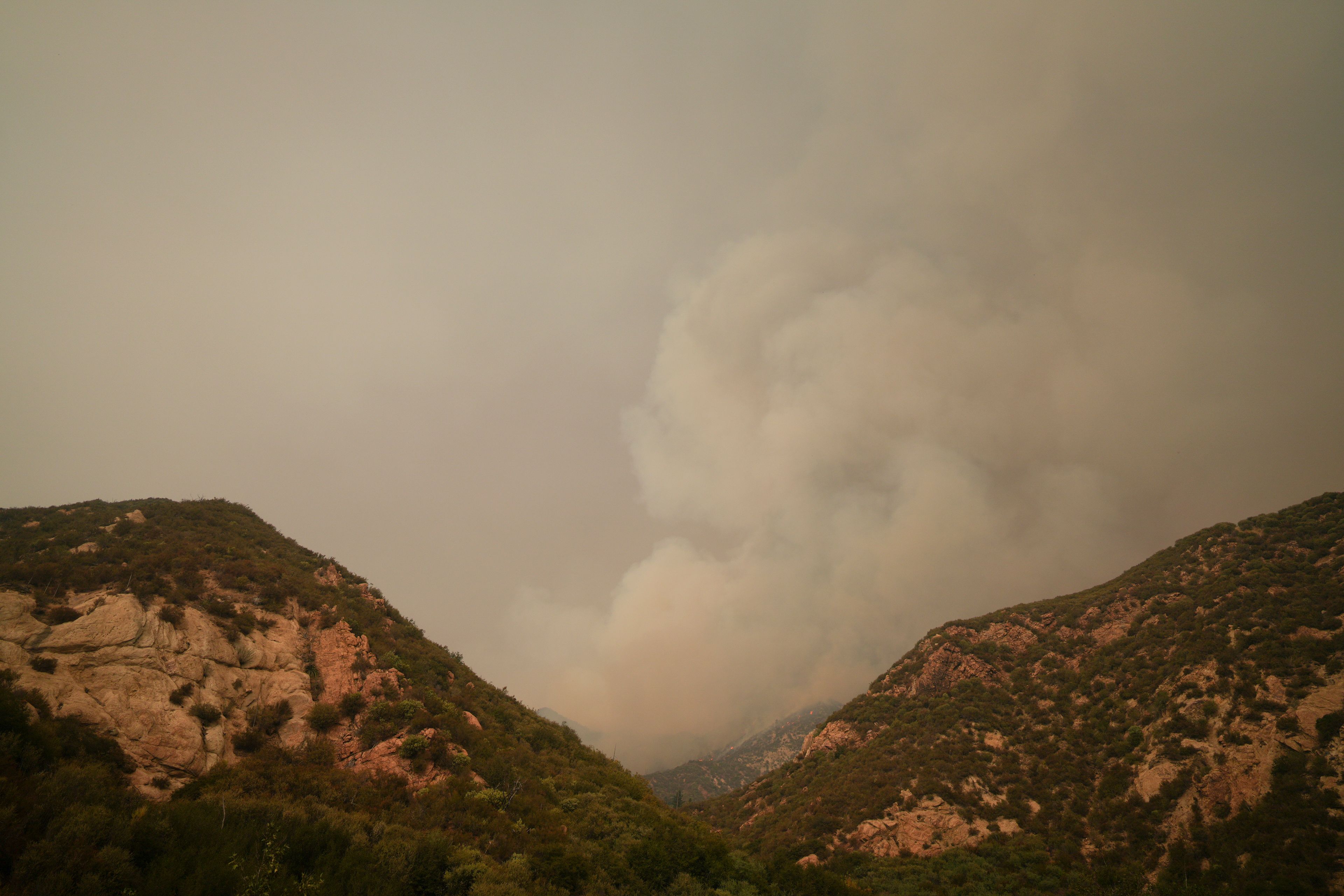 A plume of smoke from the Line Fire is seen Monday, Sept. 9, 2024, outside of Forest Falls, Calif. (AP Photo/Eric Thayer)