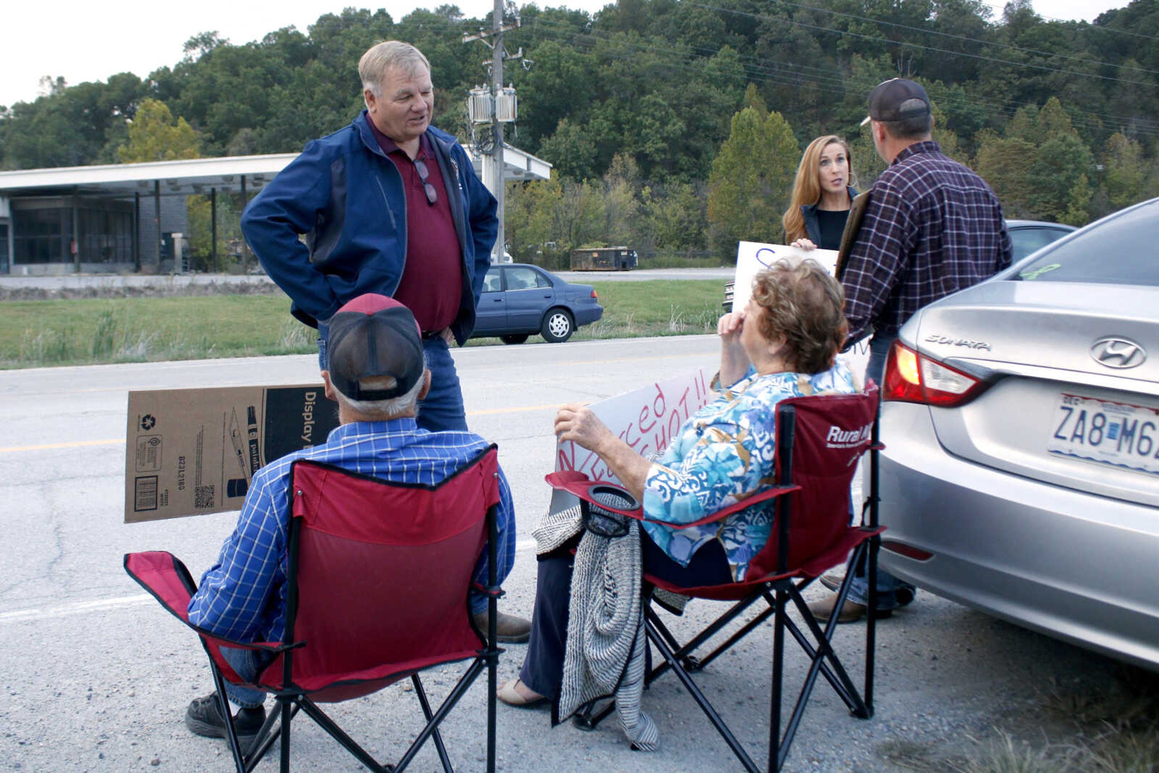 Missouri Rep. Barry Hovis and state Sen. Holly Rehder speak with protesters of Procter & Gamble's employee vaccine mandate Wednesday.