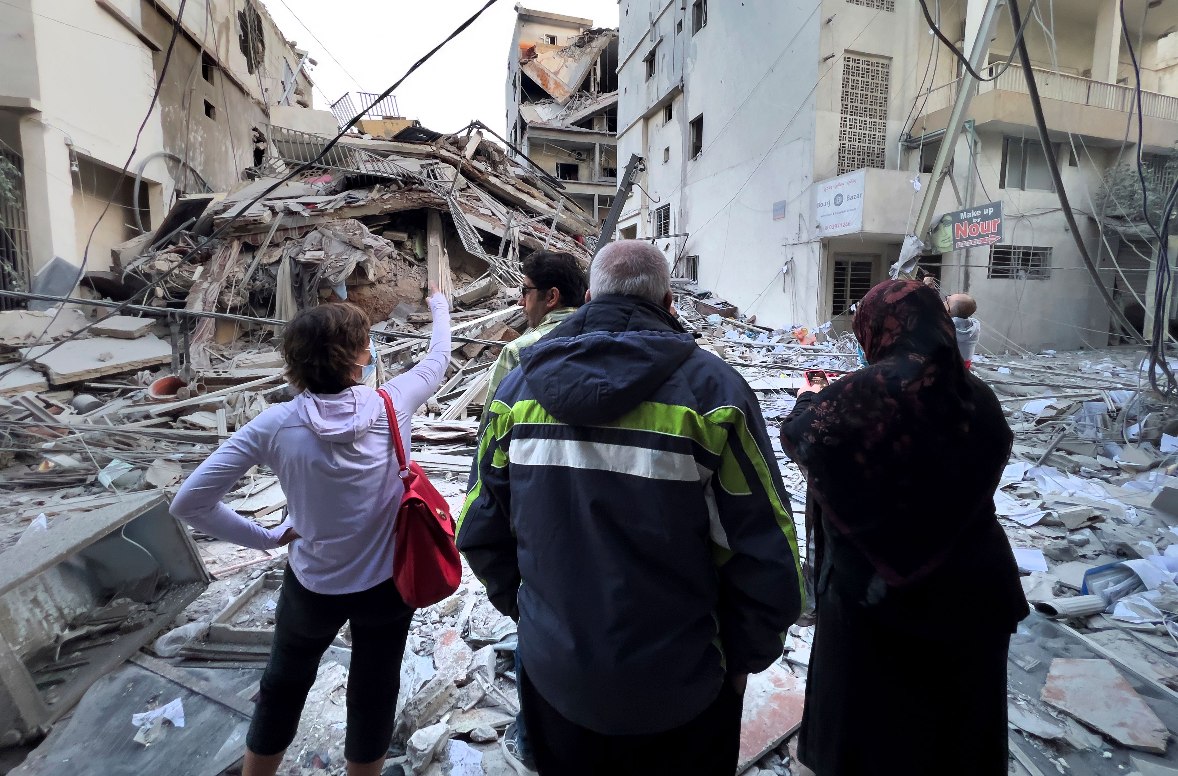 Residents check their destroyed building hit in an Israeli airstrike in Dahiyeh, in the southern suburb of Beirut, Lebanon, Thursday, Nov. 14, 2024. (AP Photo/Hussein Malla)