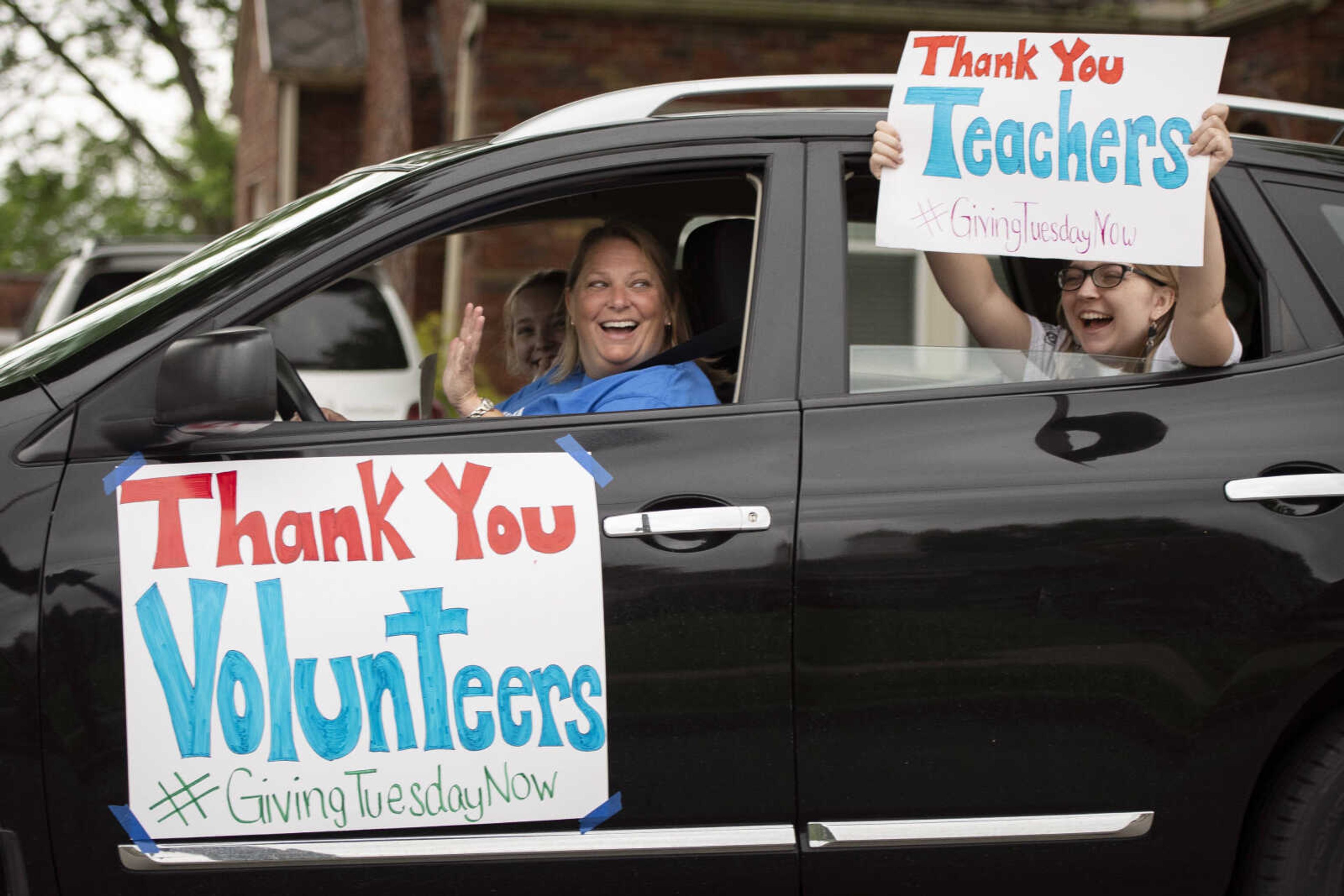 Robin Koetting, program manager for United Way of Southeast Missouri's Read to Succeed early literacy program, and her daughters Audrey Koetting, 13, (in passenger seat) and Zoe Koetting, 18, (holding sign) drive past Franklin Elementary School during UWSEMO's #GiveUnitedCarParade on Tuesday, May 5, 2020, in Cape Girardeau. Elizabeth Shelton, executive director of UWSEMO, said Tuesday was "'Giving Tuesday Now' which is being celebrated globally to help the non-profits that are helping people impacted by COVID-19." She said Tuesday was chosen for the parade "to give thanks to essential works who have stayed on the job and to volunteers who have also risked their own health to help others." Shelton said those who are able can give financially to the organization's COVID-19 fund. She said the organization supports 30 other non-profits that are helping.