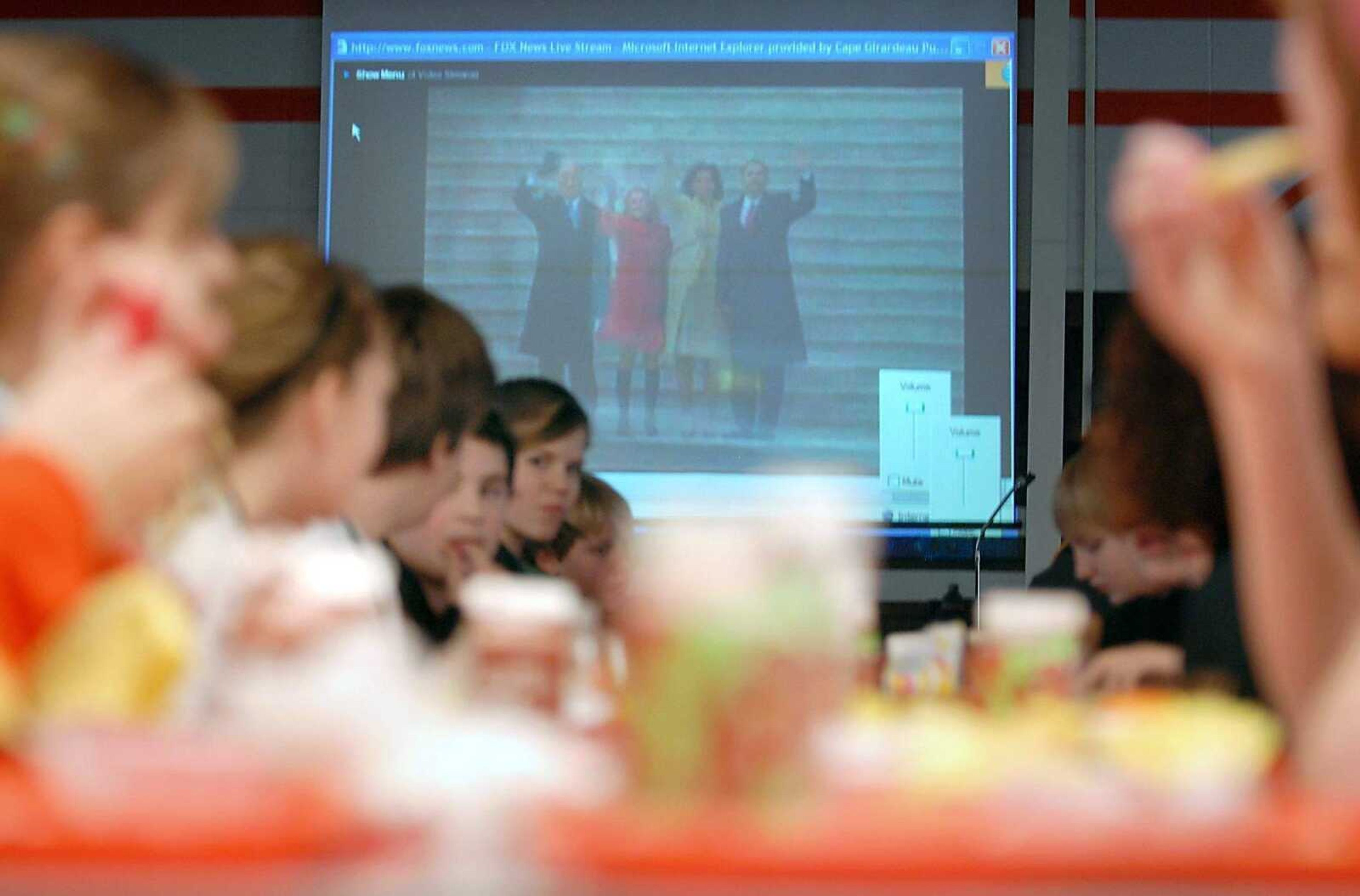 KIT DOYLE ~ kdoyle@semissourian.com<br>The Obama inauguration plays in the background of lunch Tuesday at Central Middle School in Cape Girardeau. Classes throughout the district watched the inauguration.