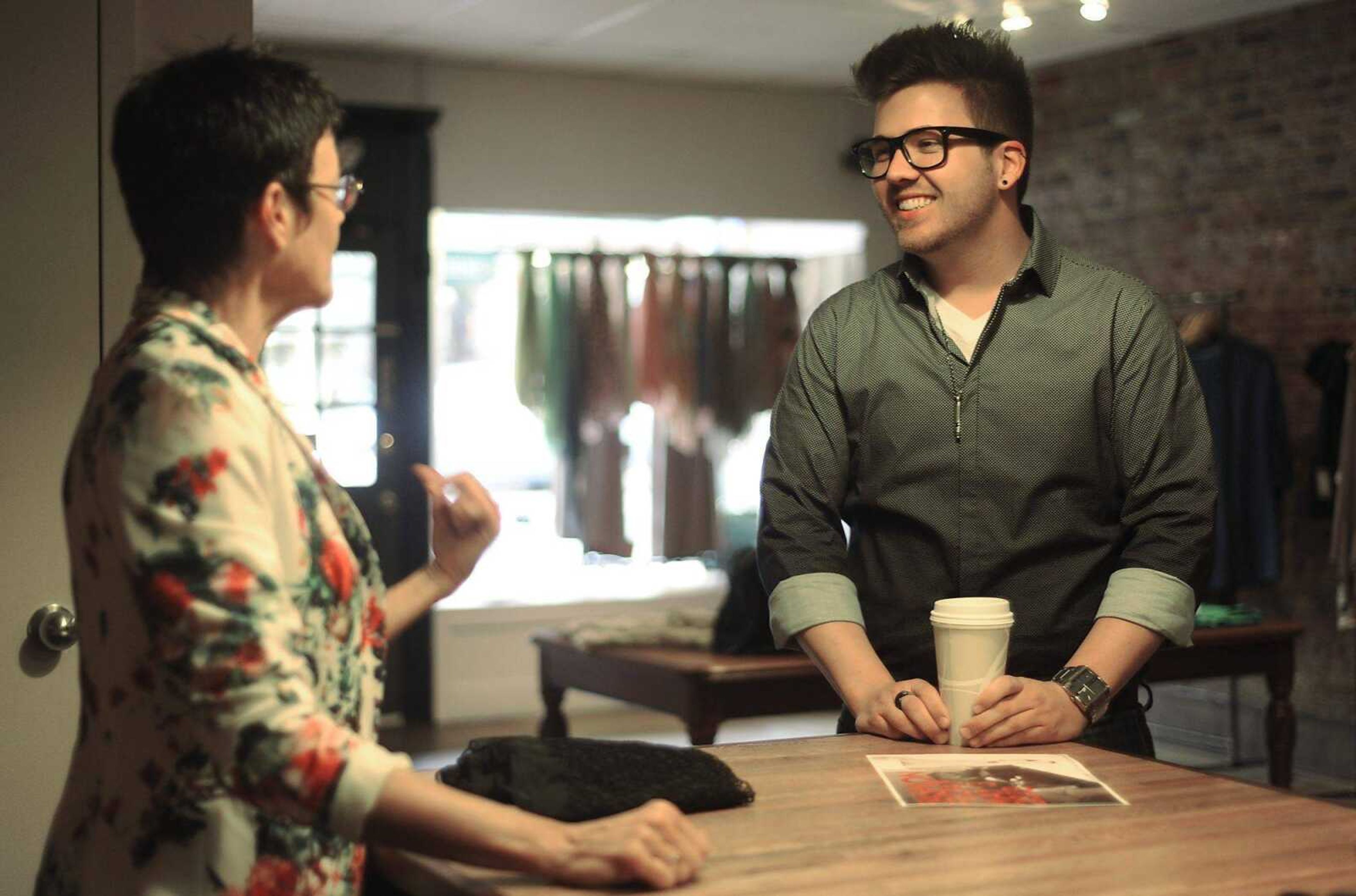 Jory Rapps, right, talks with Jill Hoehne, co-owner of Stash, 40 N. Main St., about Fashion Friday at the Cape Girardeau store.