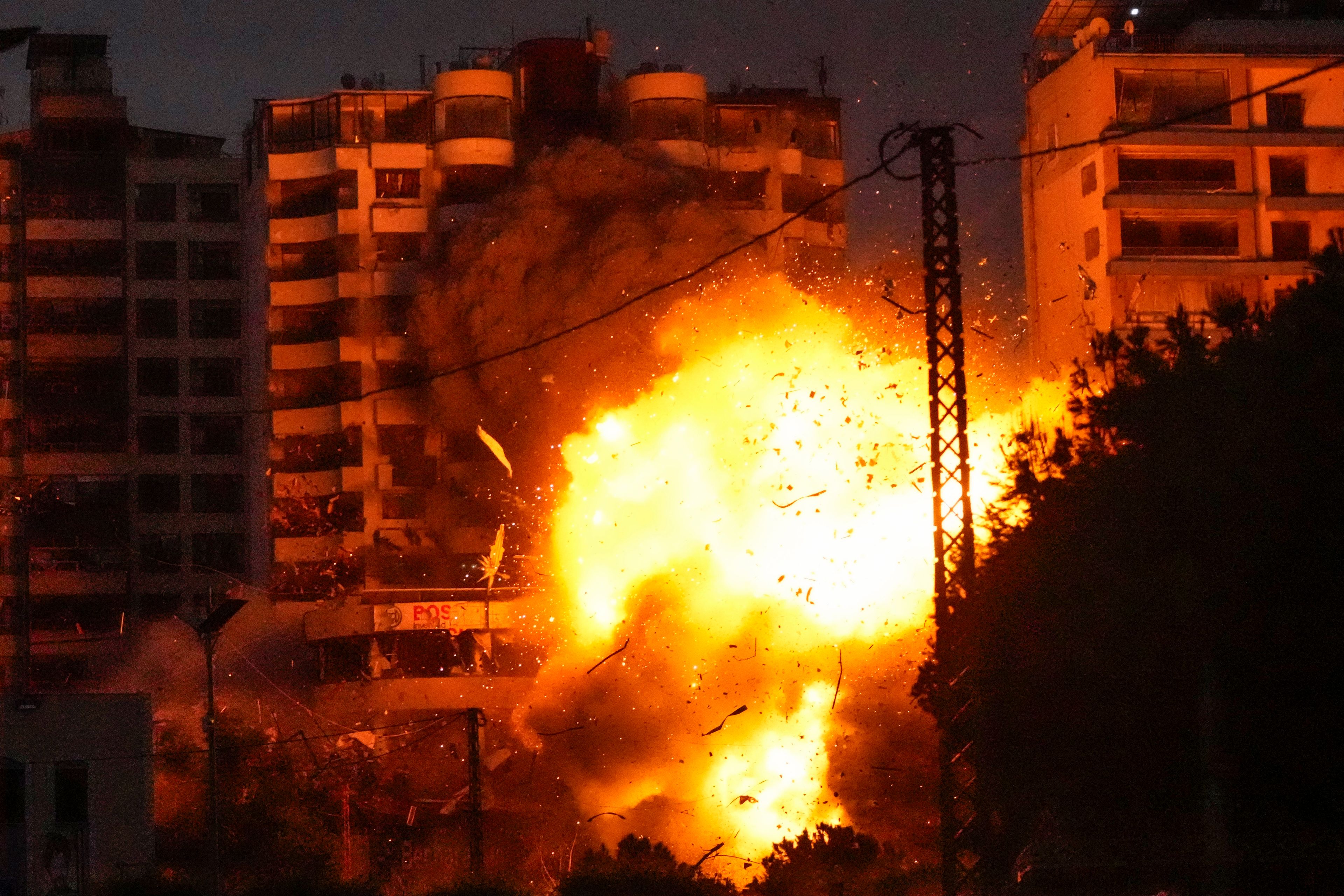 Thick smoke and flames erupt from an Israeli airstrike in Tayouneh, Beirut, Lebanon, Monday, Nov. 25, 2024. (AP Photo/Hassan Ammar)