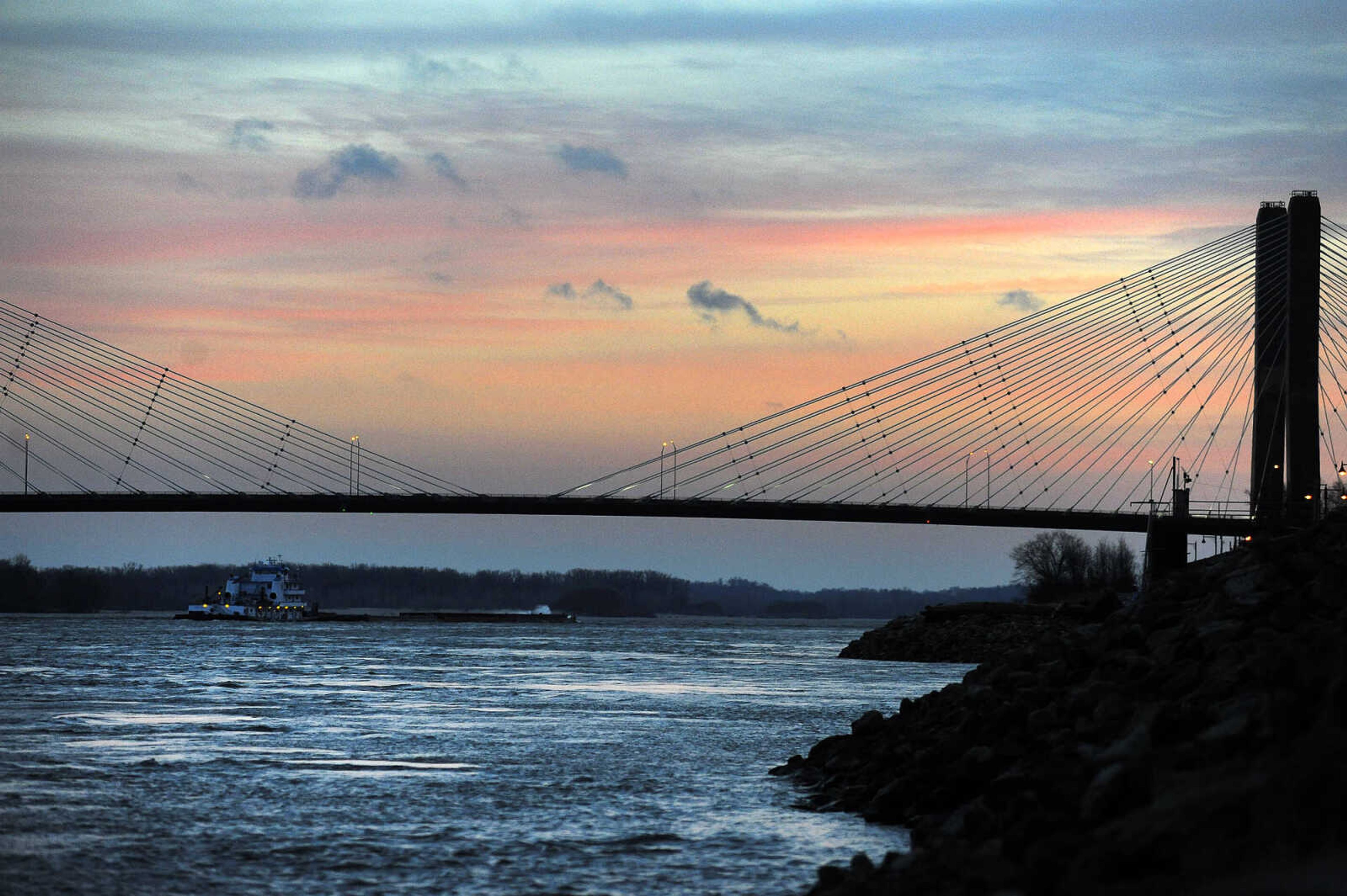 LAURA SIMON ~ lsimon@semissourian.com

A colorful sunset stretches across the sky as a towboat pushes barges south on the Mississippi River, Monday, Jan. 25, 2016, in downtown Cape Girardeau. The river recently broke its record crest of 48.49 feet in 1993 when it crested at 48.86 feet about 10 p.m. New Year's Day. According to the National Weather Service out of Paducah, the river stage Monday evening was 24.13 feet.