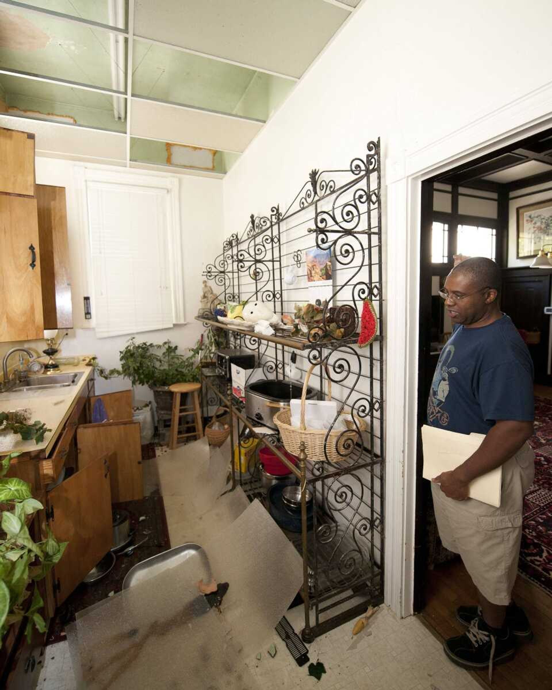 Tony Williams surveys damage at his Mineral, Va. home after an earthquake struck Tuesday, Aug. 23, 2011. Items in his home were knocked over and displaced, and the home suffered some structural damage after one of the strongest earthquakes ever recorded on the East Coast shook buildings and rattled nerves from South Carolina to New England. (AP Photo/Scott K. Brown)