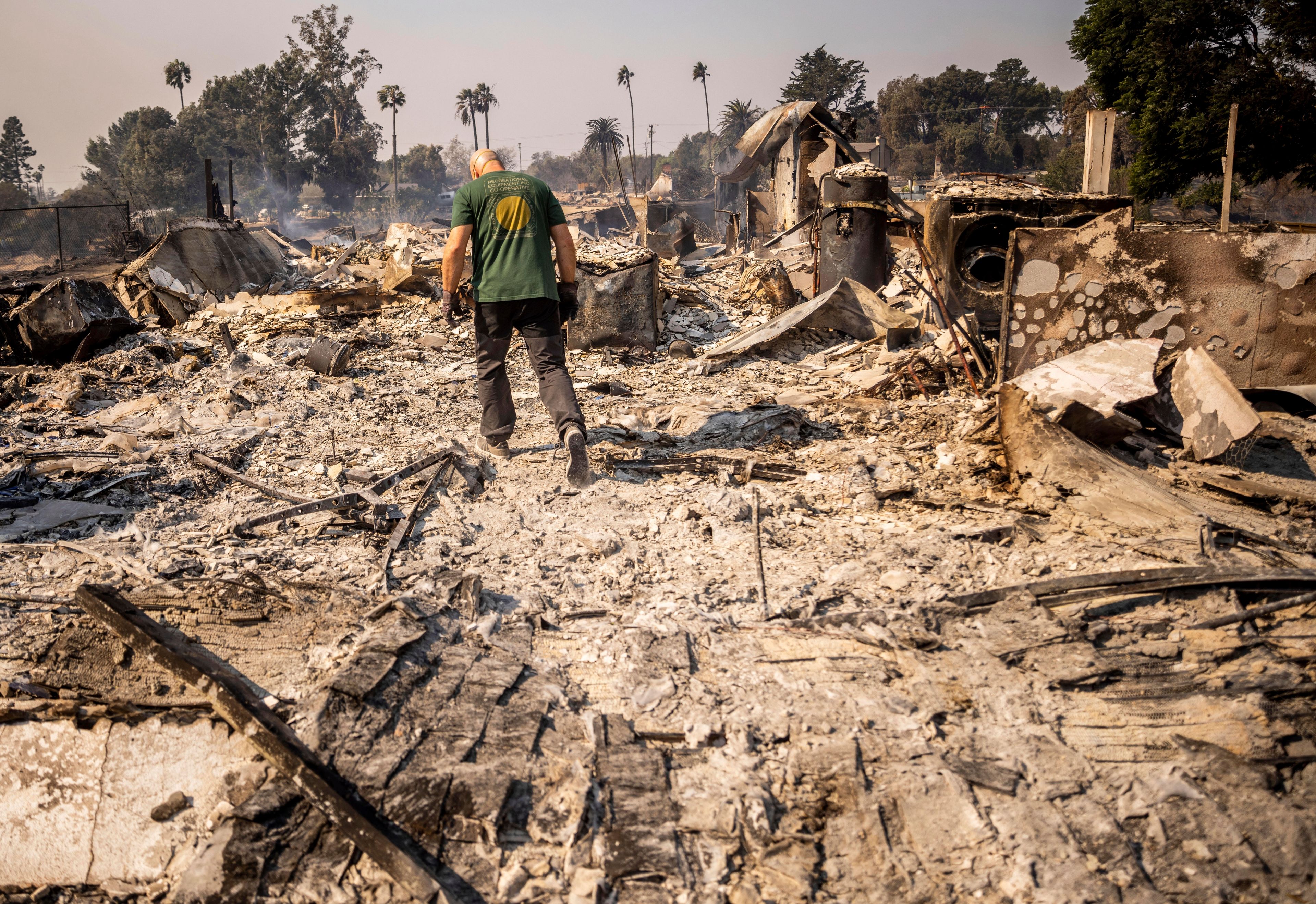 Marvin Meador walks on the remains of his fire-ravaged property after the Mountain Fire swept through, Nov. 7, 2024, in Camarillo, Calif. (AP Photo/Ethan Swope)