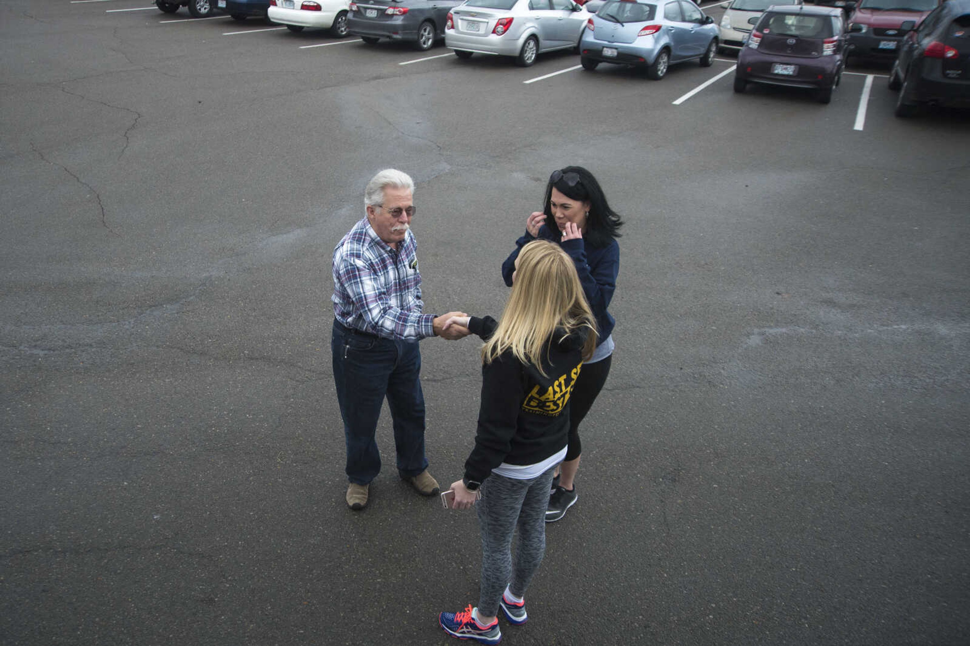 Herb Smith shakes hands with Micaela Schmiedeskamp and Angie Flores after taking their photo before they travel to Washington D.C. for the Women's March on Saturday as they get ready to leave Friday, Jan. 20, 2017 in the Scully Building parking lot at Southeast Missouri State University in Cape Girardeau.