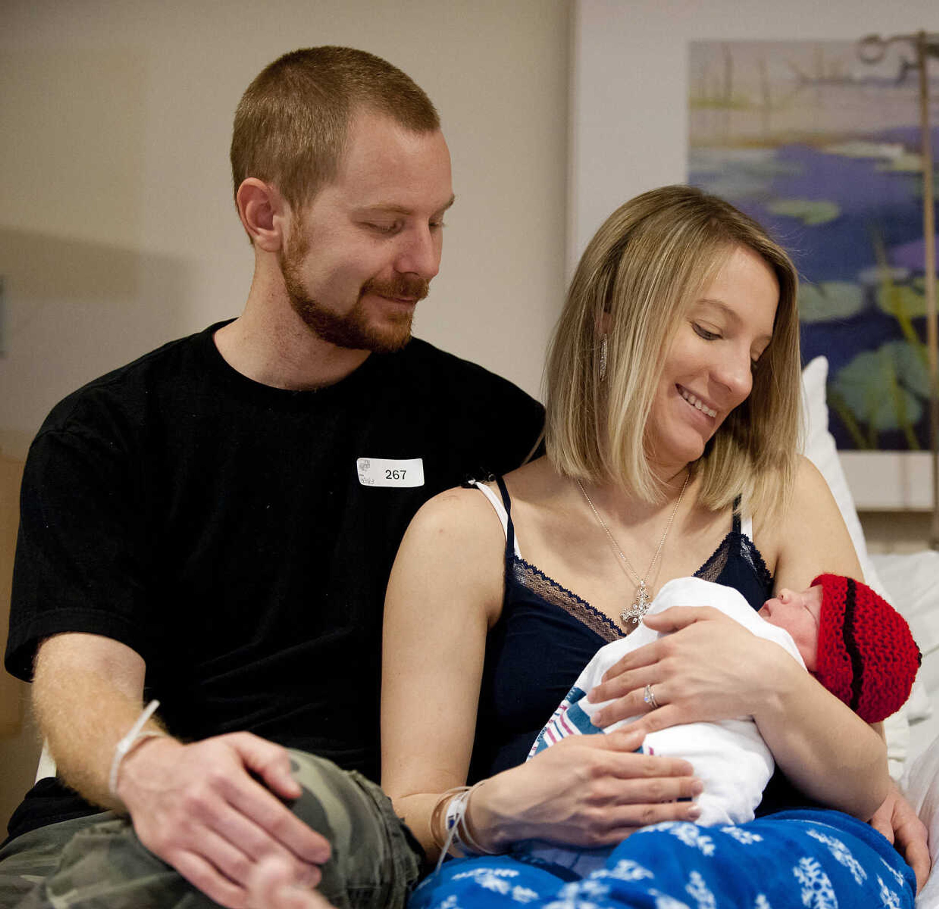 Adam Henley watches as his wife Leah holds their son, Tucker Isaiah Henley, who was born at 12:59 a.m. Wednesday, Jan. 1, at Southeast Hospital. Tucker weighs seven pounds, eleven ounces and wasn't due for a couple of more weeks. "Two and a half weeks early, he's healthy and we are extremely happy," said Leah. The couple have another son Chase, age three.