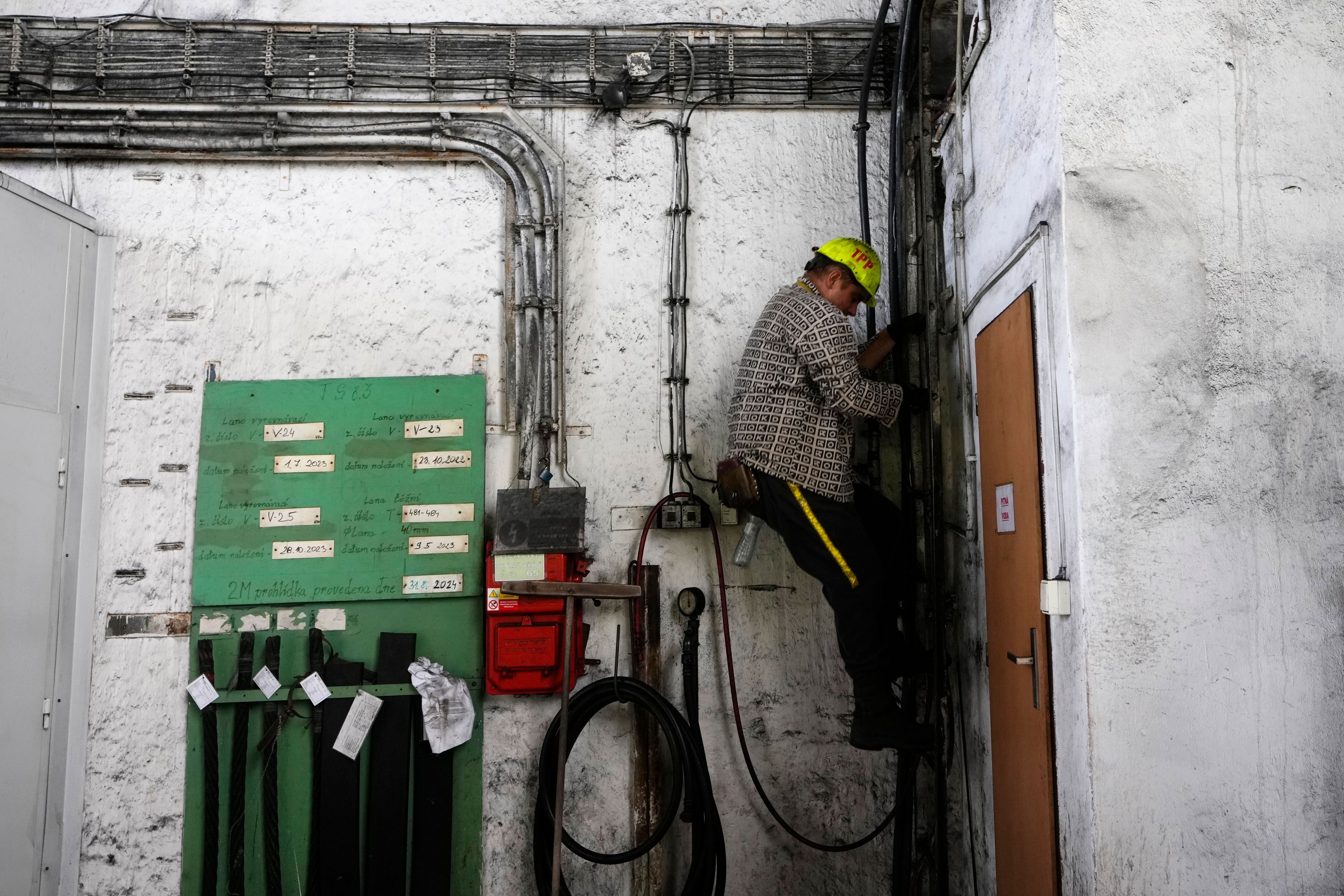 A worker walks down a ladder at the CSM coal mine in Stonava, Czech Republic, Monday, Oct. 14, 2024. (AP Photo/Petr David Josek)