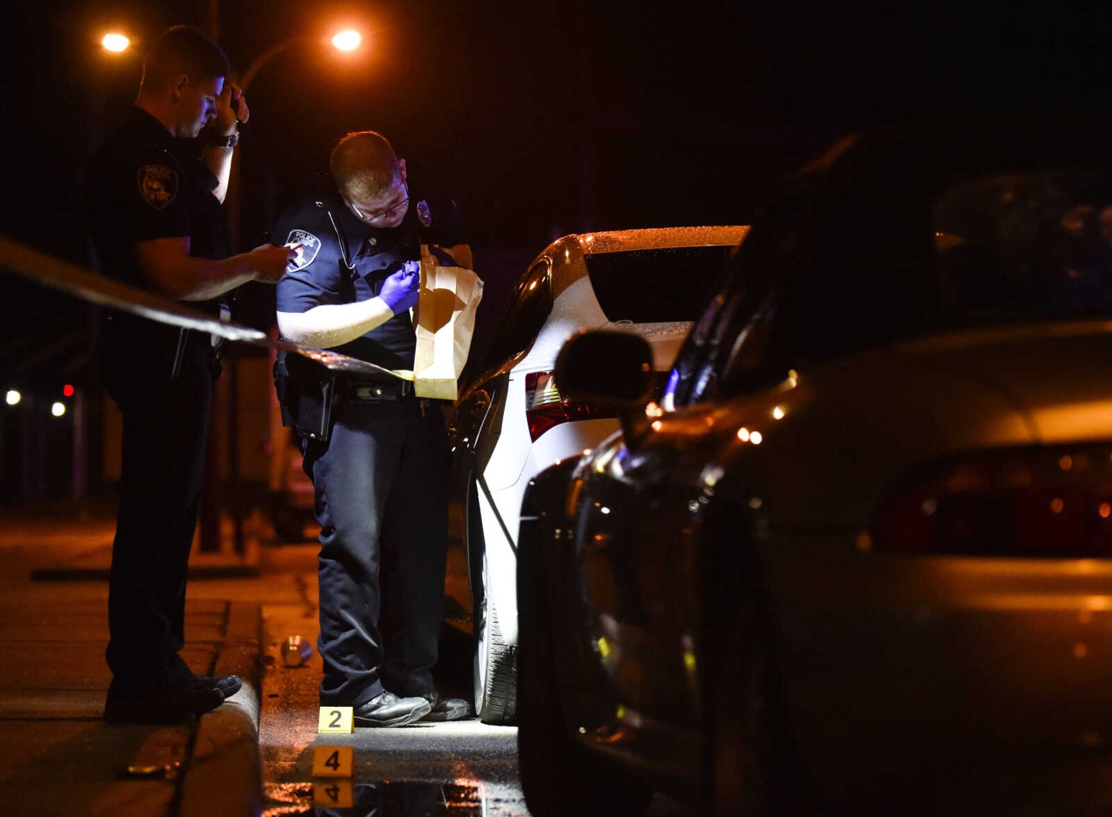 Officers with the Cape Girardeau Police Department investigate the scene of a shooting early Sunday, June 2, 2018 at the intersection of Independence and Main Street in Cape Girardeau.