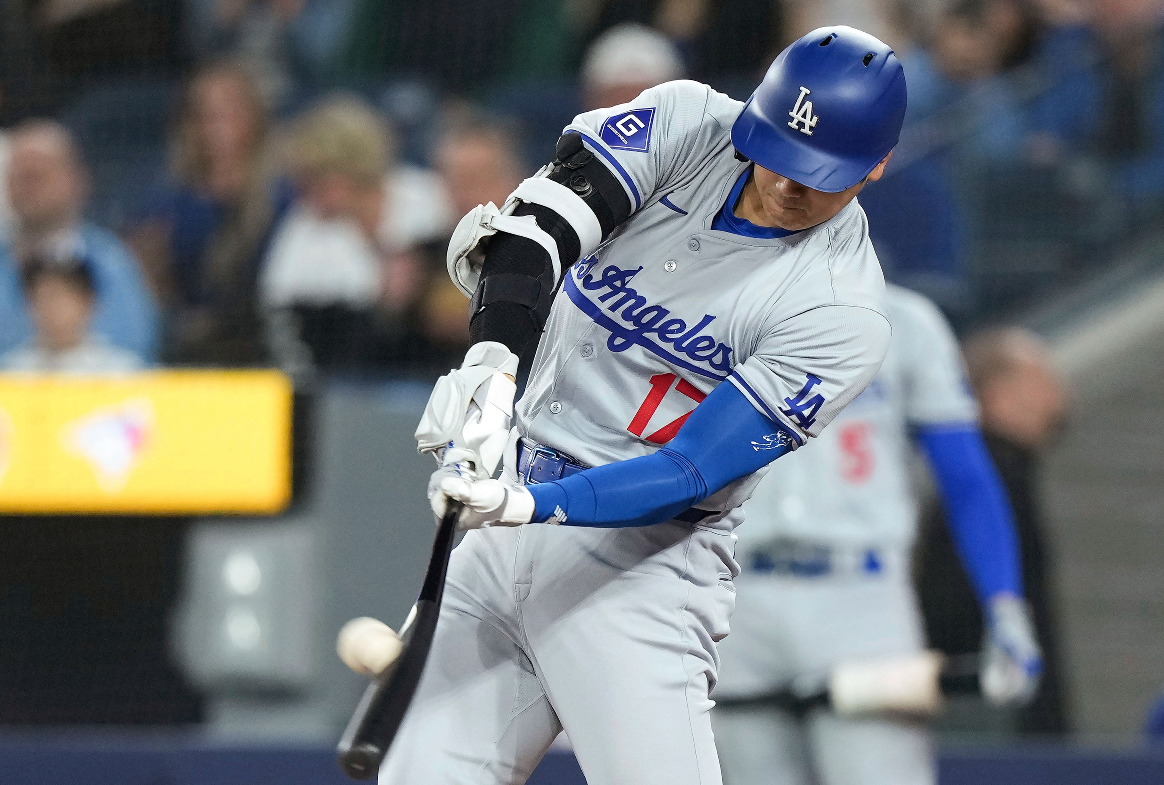 Los Angeles Dodgers designated hitter Shohei Ohtani (17) hits a solo home run next to Toronto Blue Jays catcher Danny Jansen during the first inning of a baseball game Friday, April 26, 2024, in Toronto. (Nathan Denette/The Canadian Press via AP)