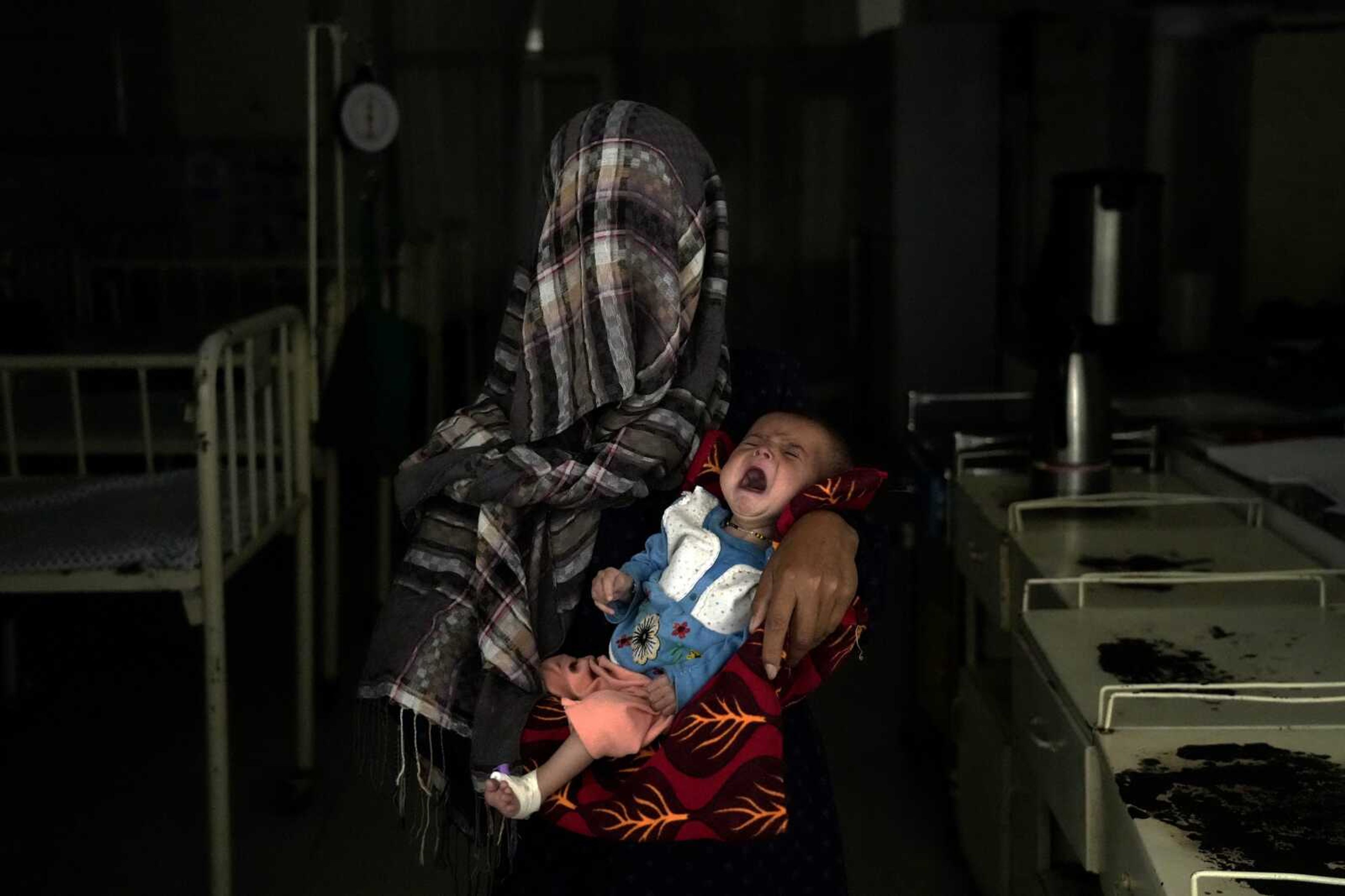 Nazia, 30, who has lost four children due to severe malnutrition, holds her malnourished baby in a hospital May 19 in Parwan province north of Kabul, Afghanistan.