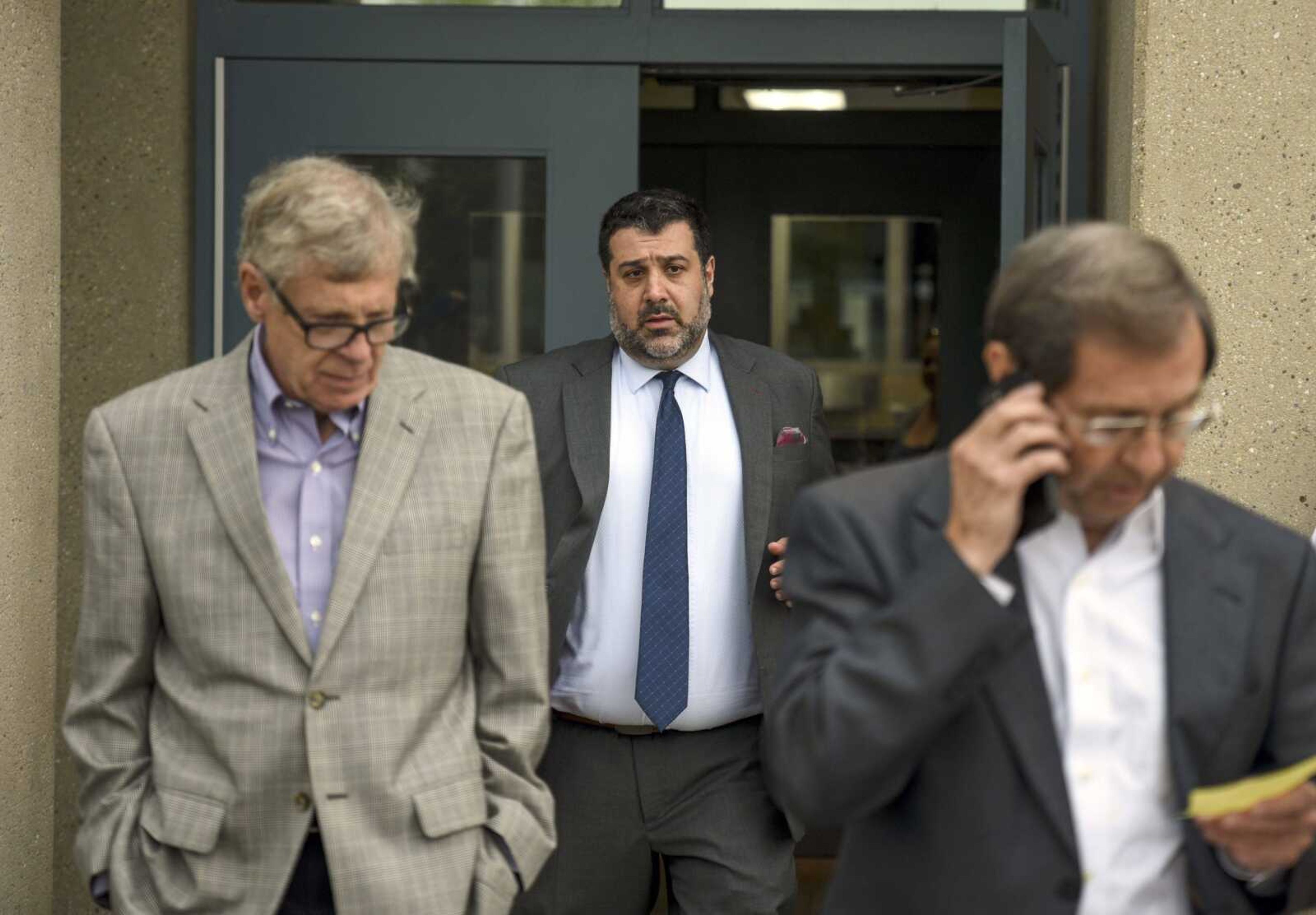 Attorneys for David Robinson, from left, Steve Snodgrass, Javad Khazaeli and Charlie Weiss gather outside of the Jefferson City Correctional Center after getting word Robinson will not be released Monday in Jefferson City, Missouri.