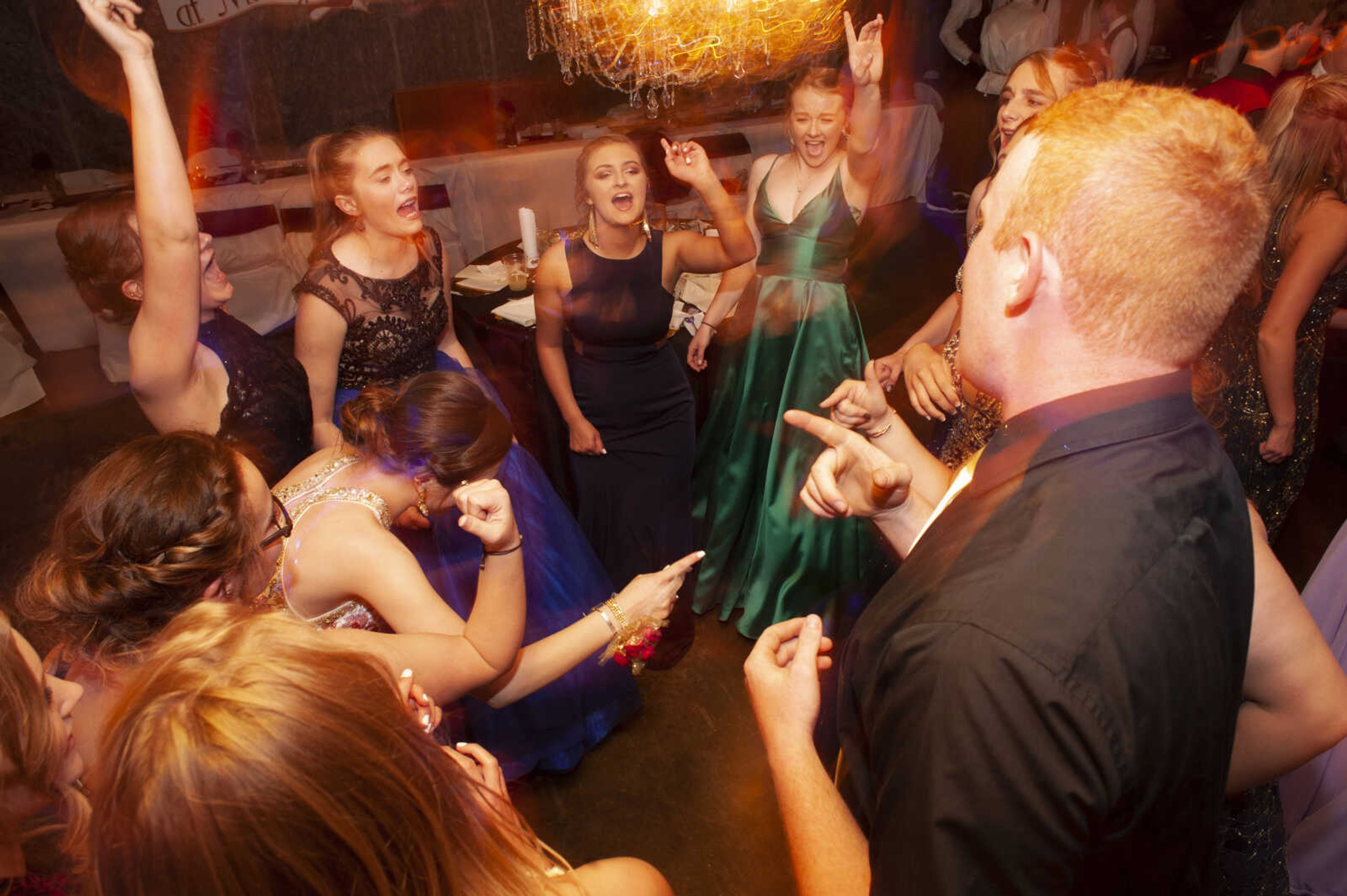 Prom guests sing along with Bon Jovi's "Livin' On A Prayer" during Leopold High School's "Masquerade at Midnight" prom Saturday, April 27, 2019, in Leopold.