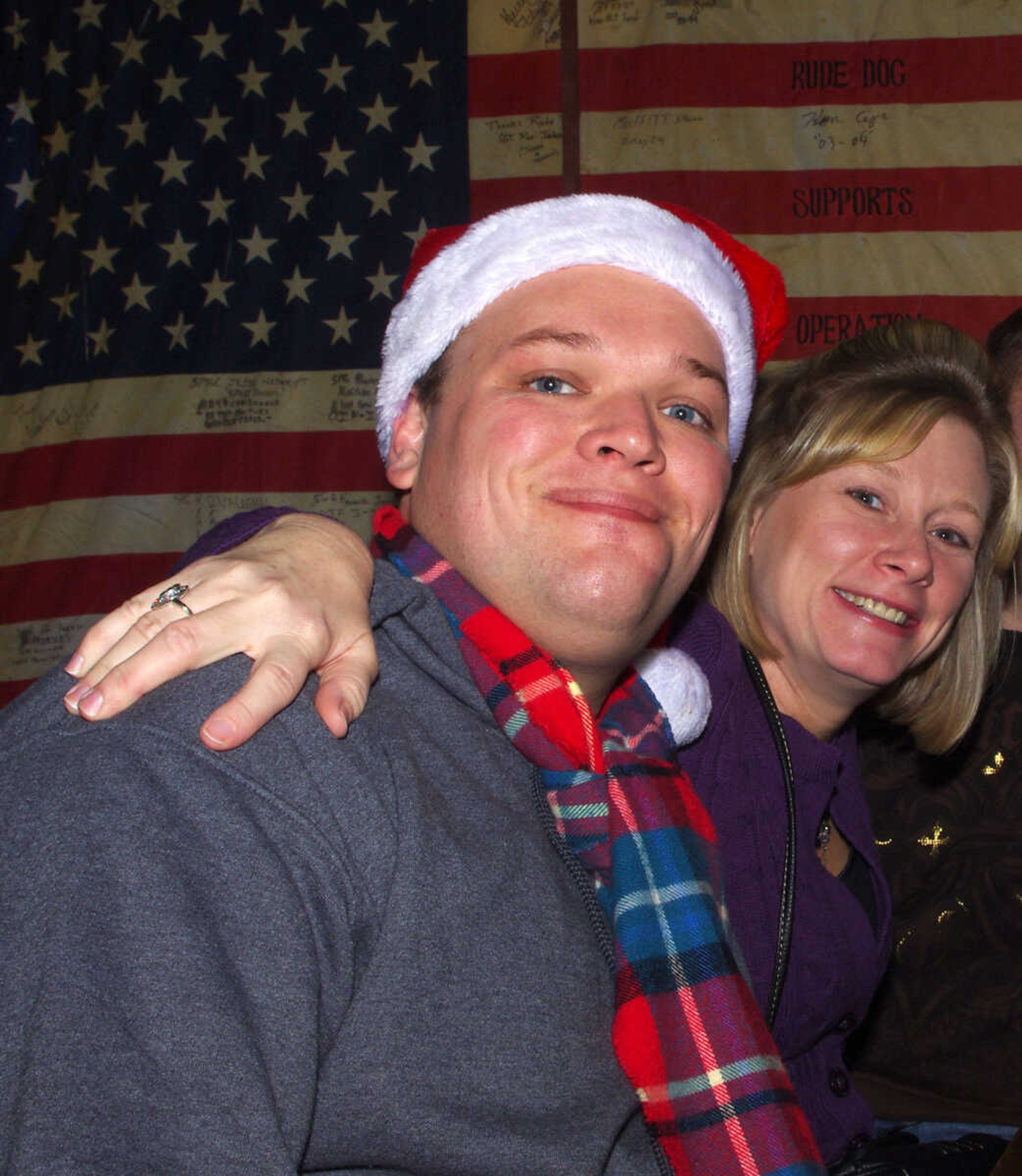 Cole Windler, left, and Nicke Becky Lohman enjoy the downtown night life during the 10th annual Happy Slapowitz's Toy Bash on Thursday Dec. 13, 2012.