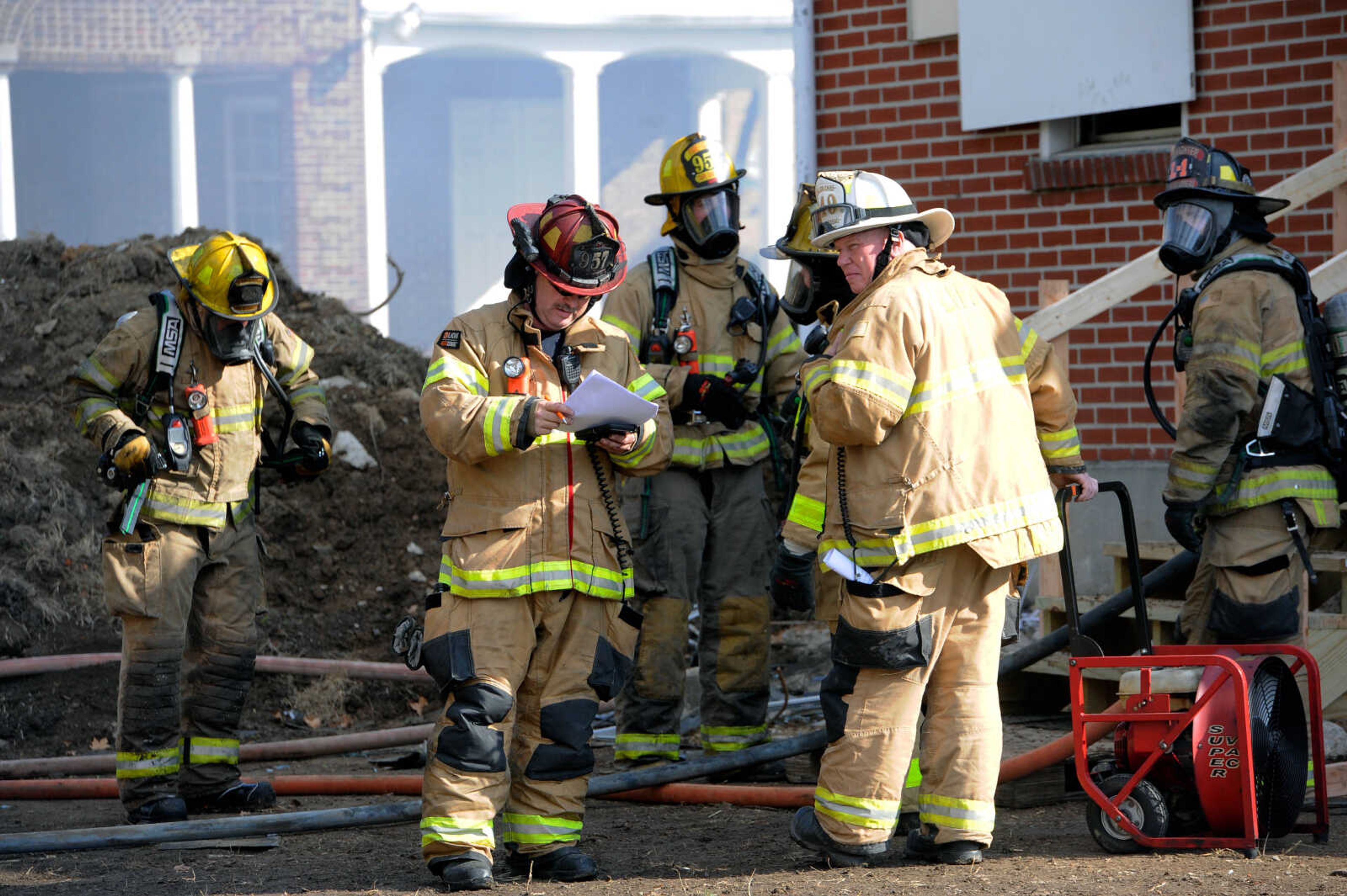 Cape Girardeau Fire Department Captain Michael Allen (left) and Gordonville Fire Protection District battalion chief Sean Mitchell lead the live burn exercise at 222 N. Middle St. in Cape Girardeau held by the Cape Girardeau Fire Department on Friday, Oct. 23, 2020.&nbsp;