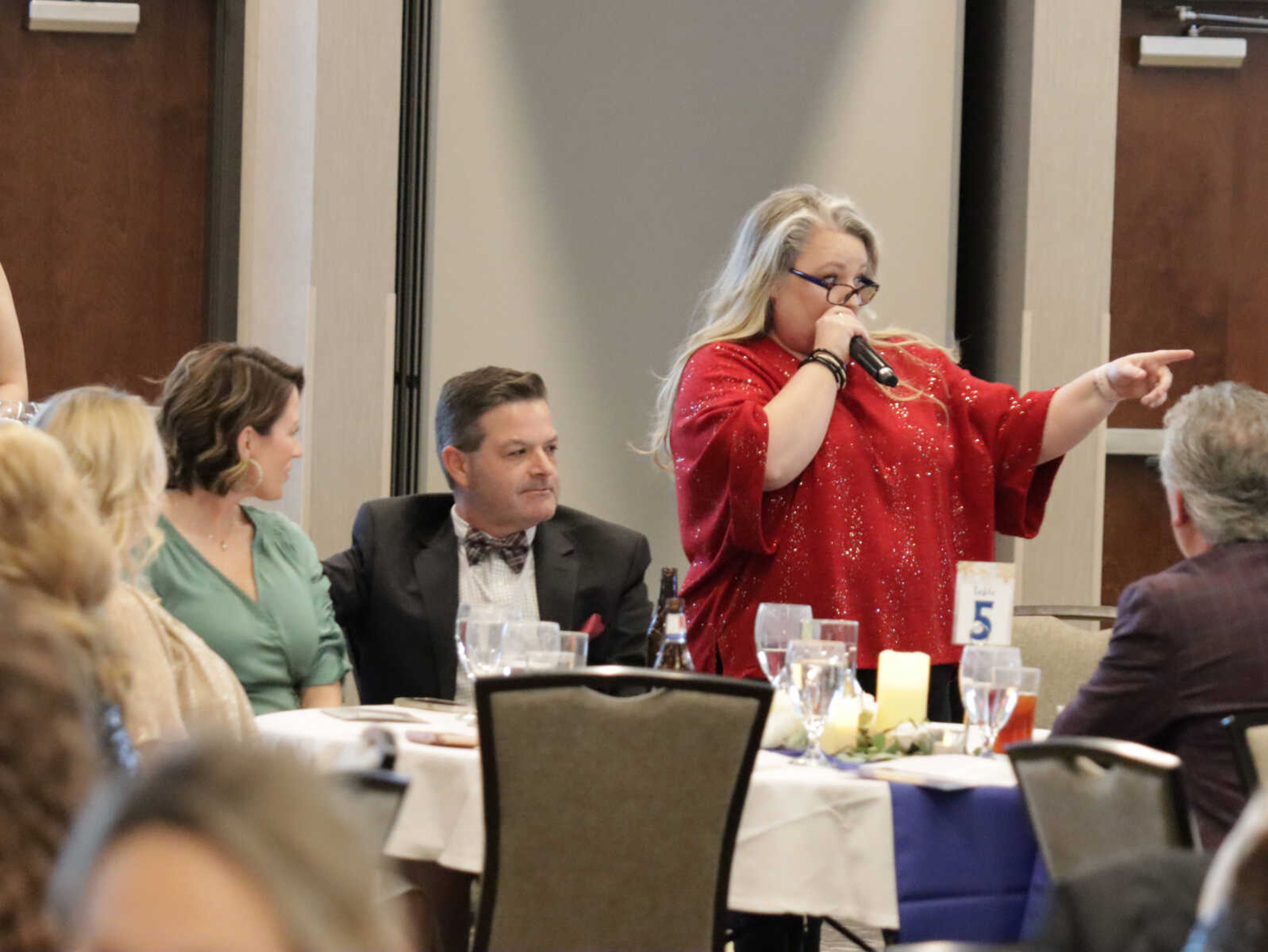 Laura Holter keeping track of the bidding between one person and the one right by her.