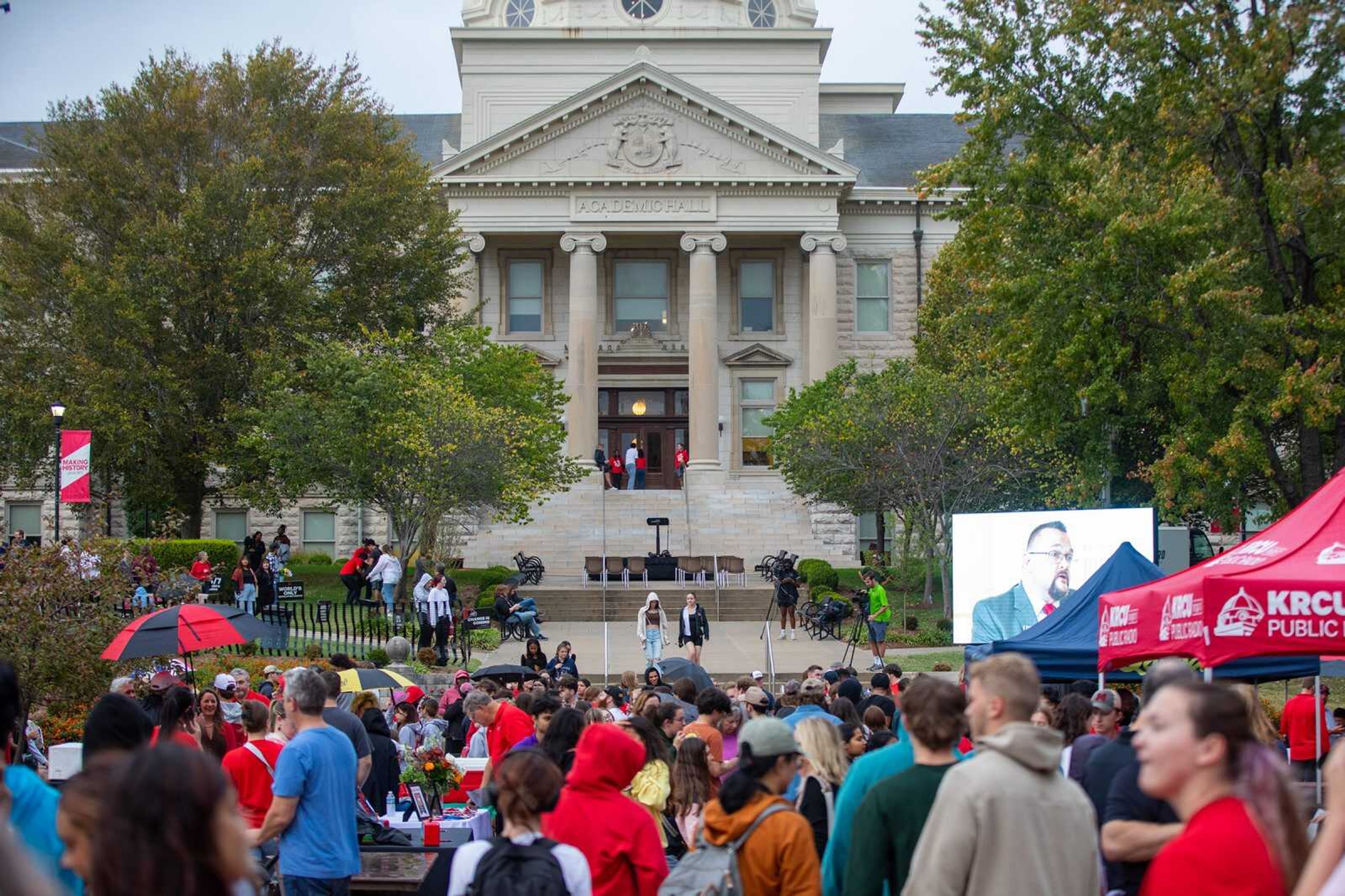 Students and alumni frame Academic Hall at a block party during the 2023 Homecoming festivities.