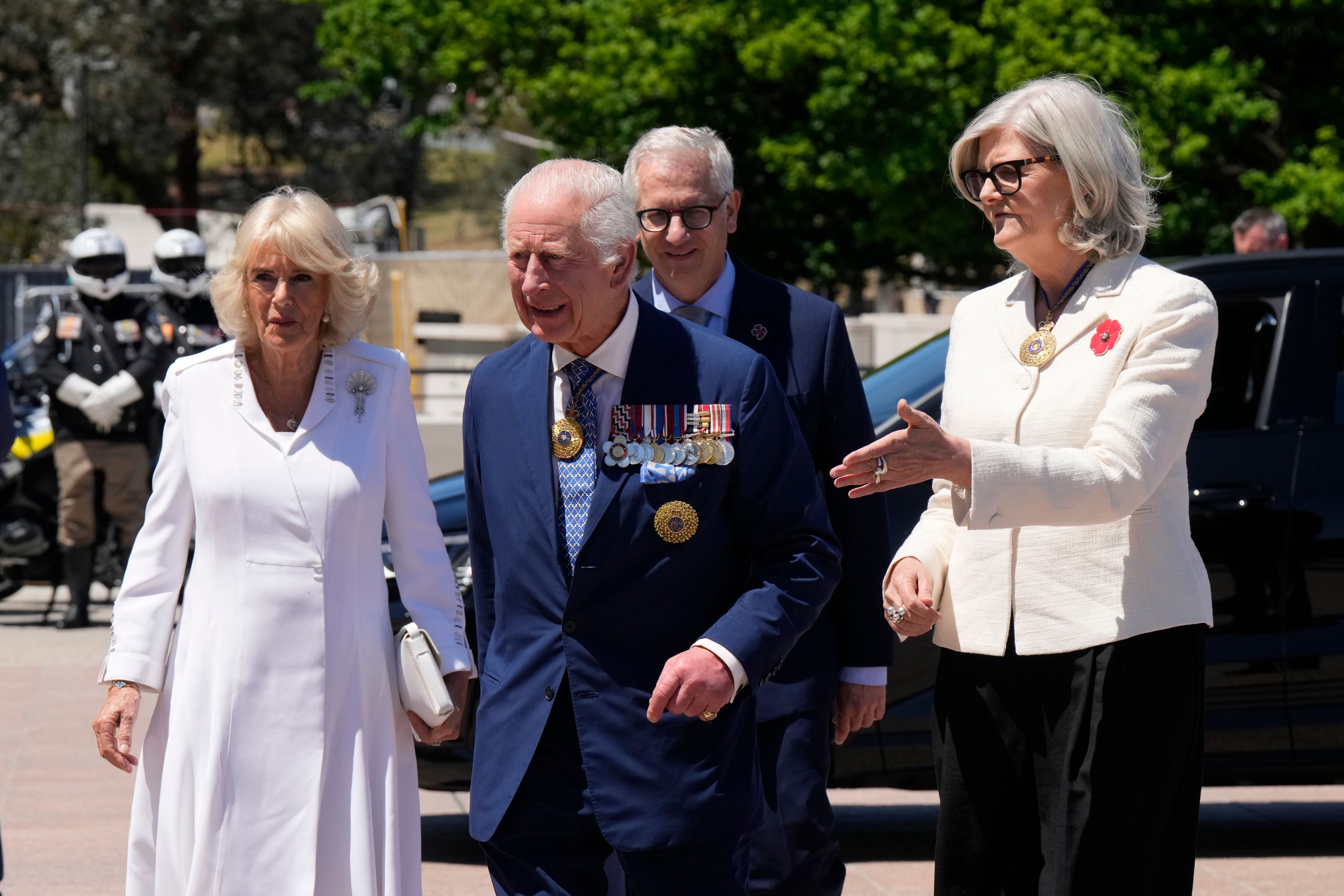 Australia's Governor-General Sam Mostyn, right, escorts Britain's King Charles III, front center, and Queen Camilla as they arrive at the Australian War Memorial in Canberra Monday, Oct. 21, 2024. (AP Photo/Mark Baker, Pool)