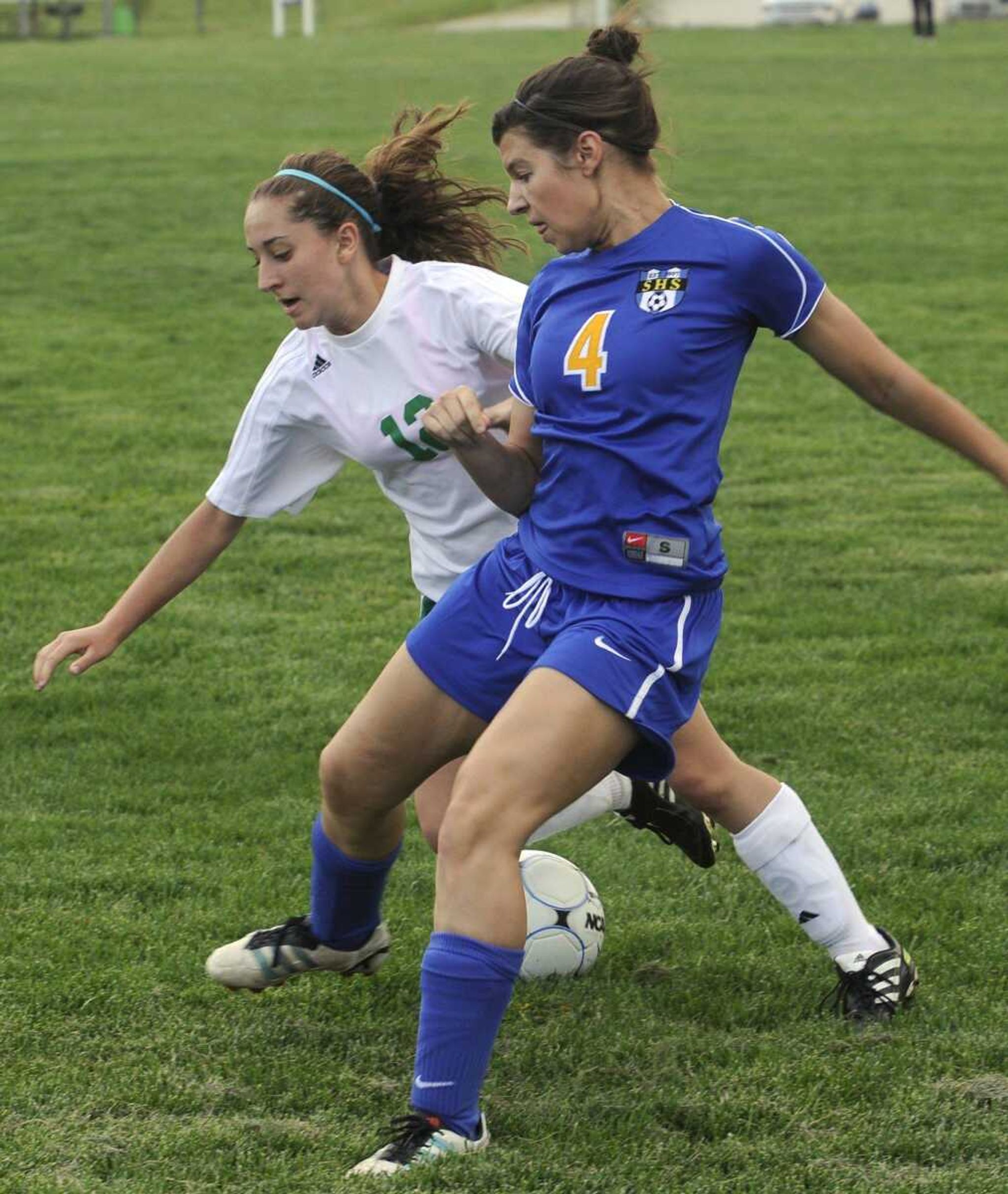 Perryville's Libbi Schnurbusch, back, battles Seckman's Alyssa Theissen during the first half Friday in Perryville, Mo. (Fred Lynch)