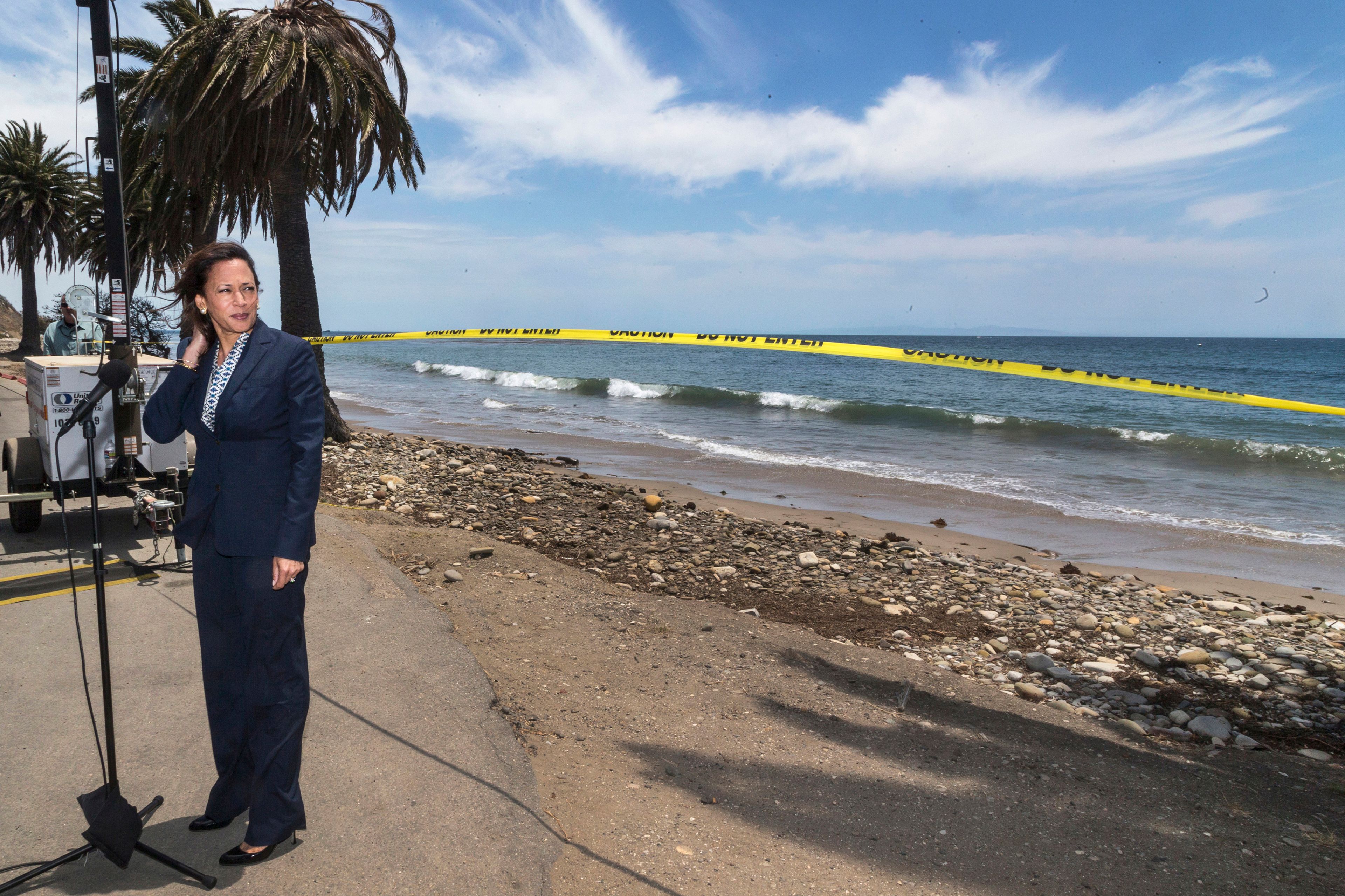 FILE - California Attorney General looks back at closed off areas affected by an oil spill at Refugio State Beach, north of Goleta, Calif., on Thursday, June 4, 2015. (AP Photo/Damian Dovarganes, File)