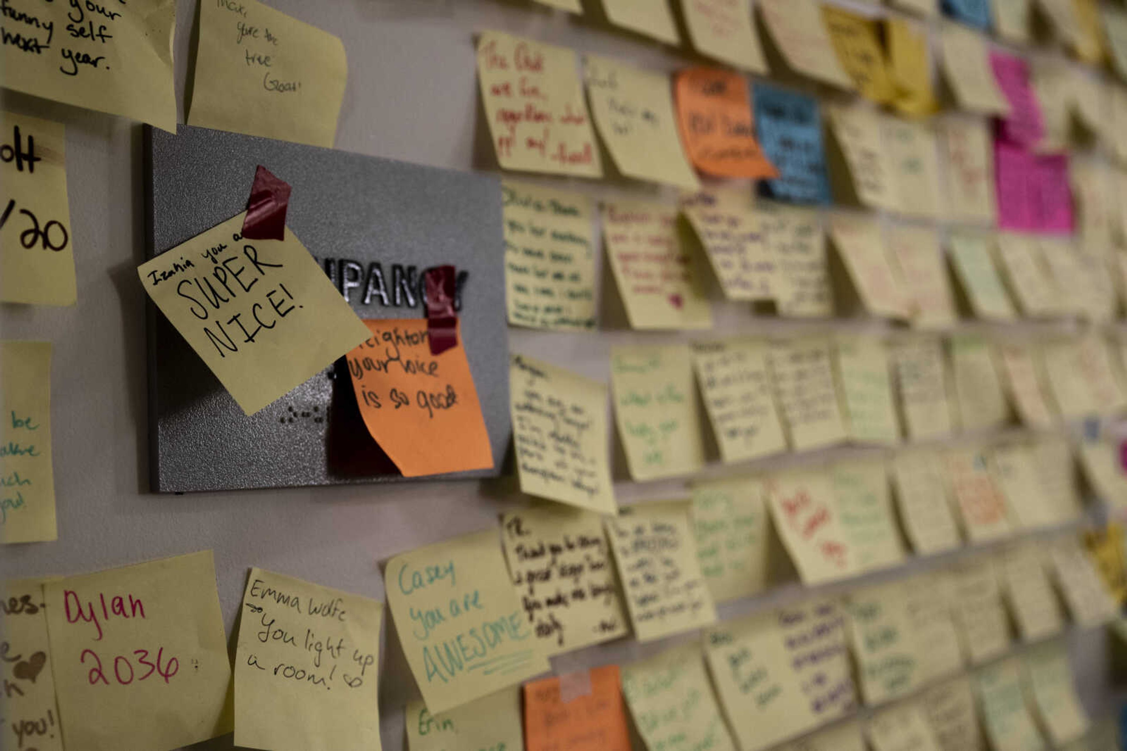 Post-it notes full of positive remarks and compliments hang on a wall backstage during the media night of Cape Central High School's spring musical production of "Mamma Mia!" Wednesday, April 10, 2019, in Cape Girardeau. "We write compliments to help keep everyone encouraged," said Morgan Green, 17, portraying the role of Tanya Chesam-Leigh.