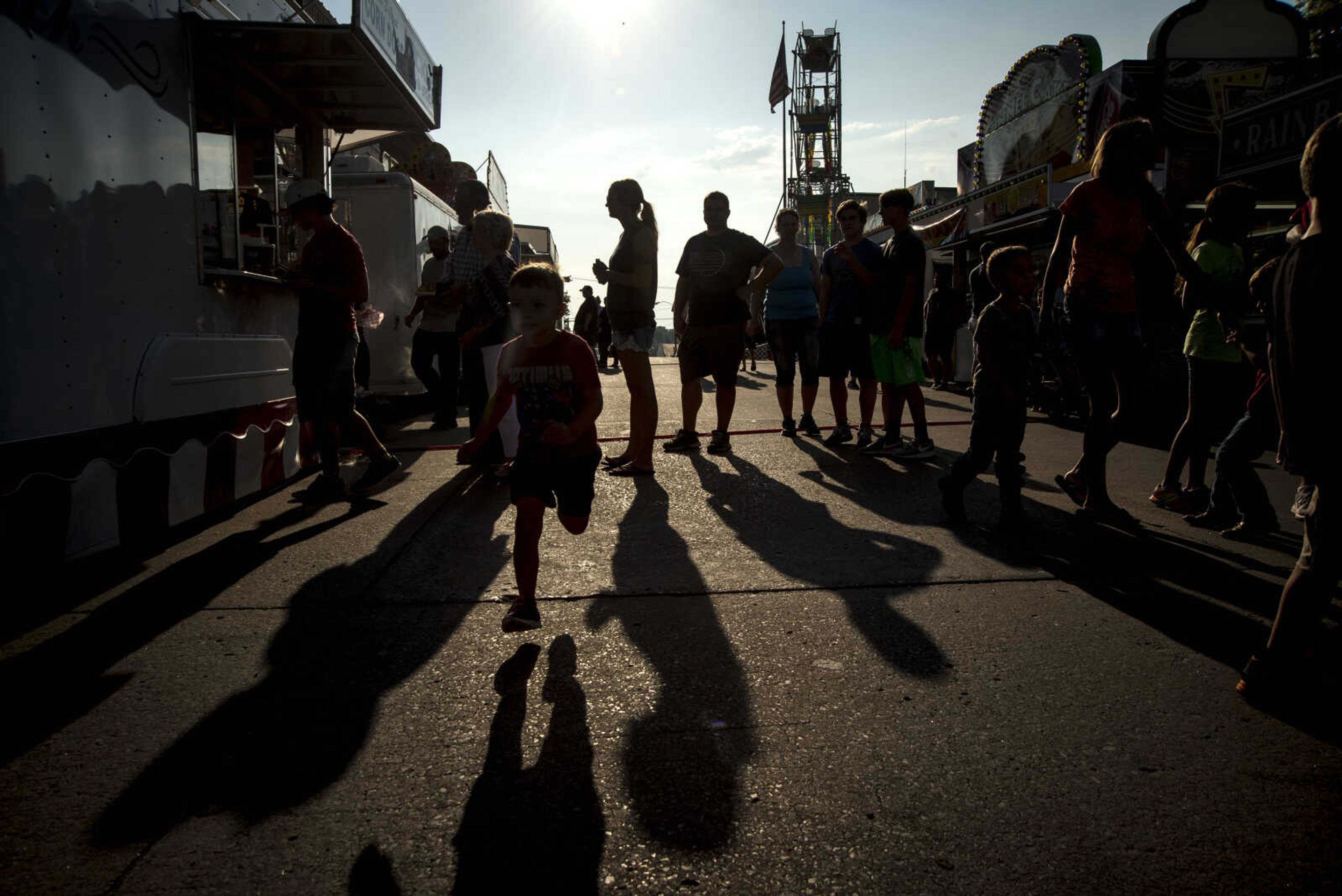 People roam around at the Jackson Homecomers Tuesday, July 25, 2017 in Uptown Jackson.