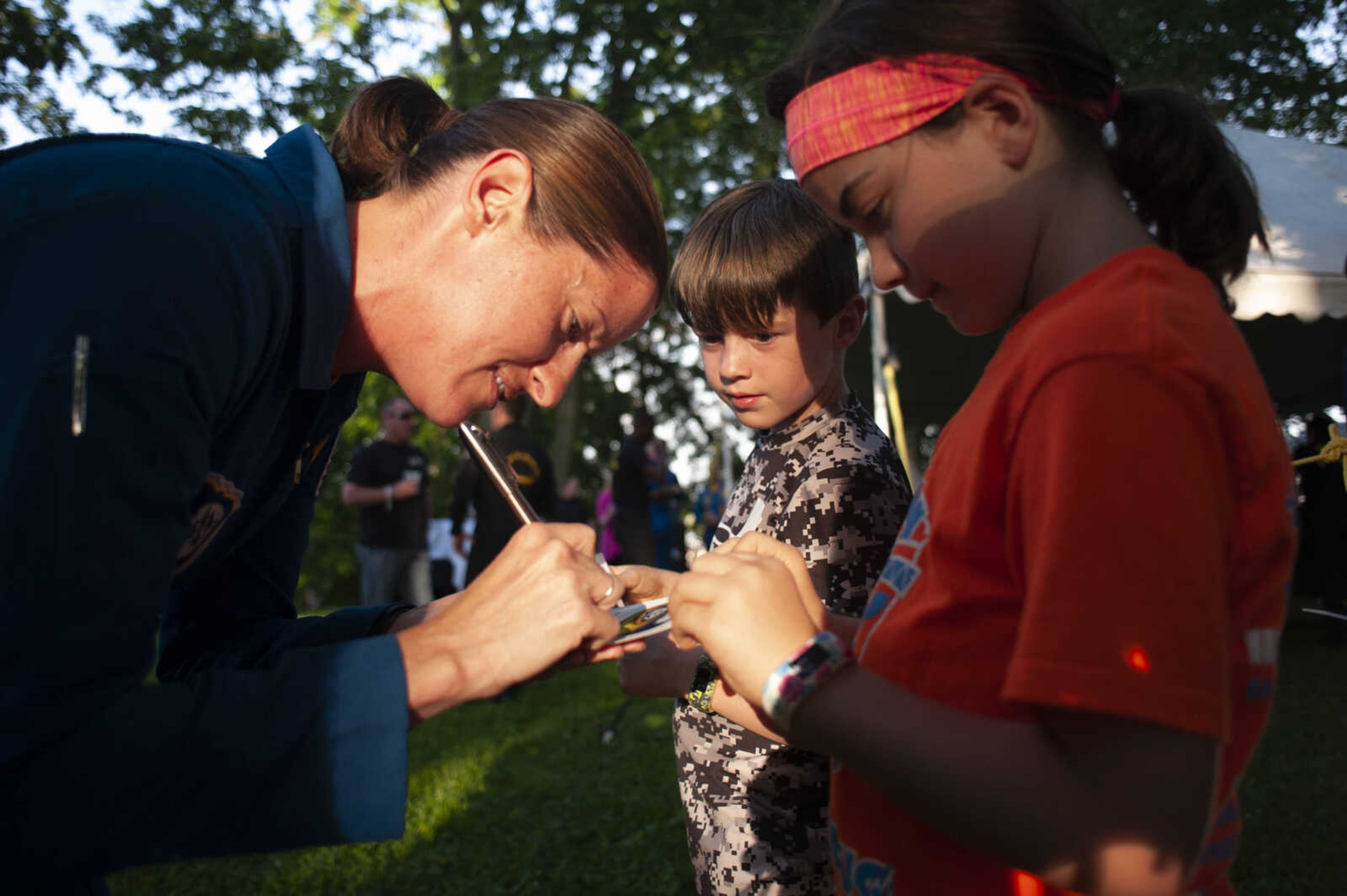 Blue Angels supply corps officer Kristin Toland, from Sedalia, Mo., meets with Kinley Hillis, 9, right, and Charles Hillis, 8, of Jackson, during the season's first Tunes at Twilight on Friday, May 17, 2019, at Ivers Square near Common Pleas Courthouse in Cape Girardeau.